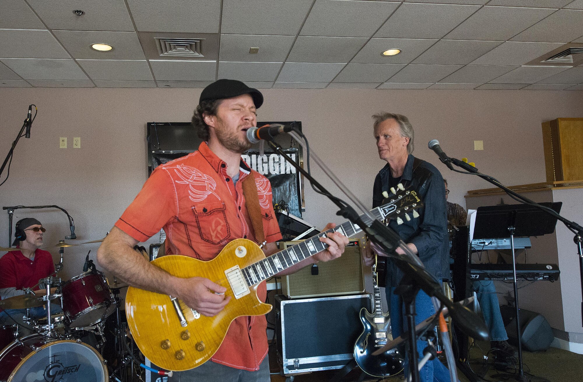 Brooks Hoover, singer; Dan Qualkinbush, bass guitar; and Paul Howe, drums; perform with the rest of the classic-rock band Moe Diggin April 1, 2016, at the Trail’s End Event  Center grand opening on F.E. Warren Air Force Base, Wyo. The center’s Wrangler Lounge will be open each weekend and other facilities can be booked for events. (U.S. Air Force photo by R.J. Oriez)