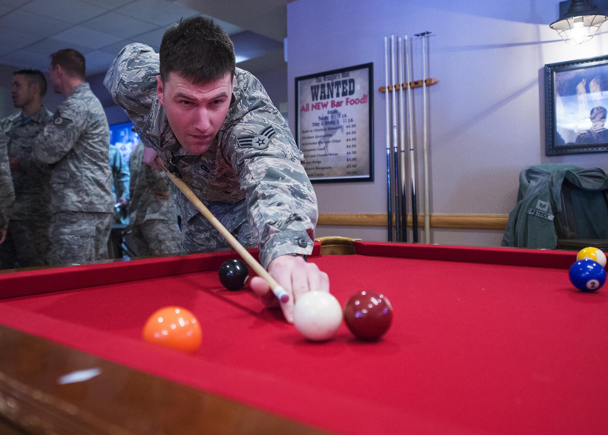 Senior Airman Tom O’Conner, 90th Munitions Squadron, takes aim during a pool game April 1, 2016, in the Trail’s End Event Center’s Wrangler Lounge on F.E. Warren Air Force Base, Wyo.  O’Conner was taking part in the event center’s reopening after being closed for several months for refurbishing. (U.S. Air Force photo by R.J. Oriez)