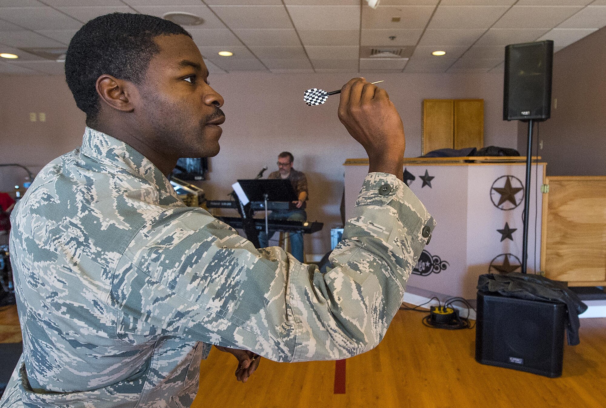 First Lt Darrell Cousin, 319th Missile Squadron, takes aim while throwing darts April 1, 2016, in the Trail’s End Event Center’s Wrangler Lounge on F.E. Warren Air Force Base, Wyo. The lounge is slated to be open Thursdays from 4 to 10 p.m. as well as Fridays and Saturdays from 3 to 11 p.m. (U.S. Air Force photo by R.J. Oriez)