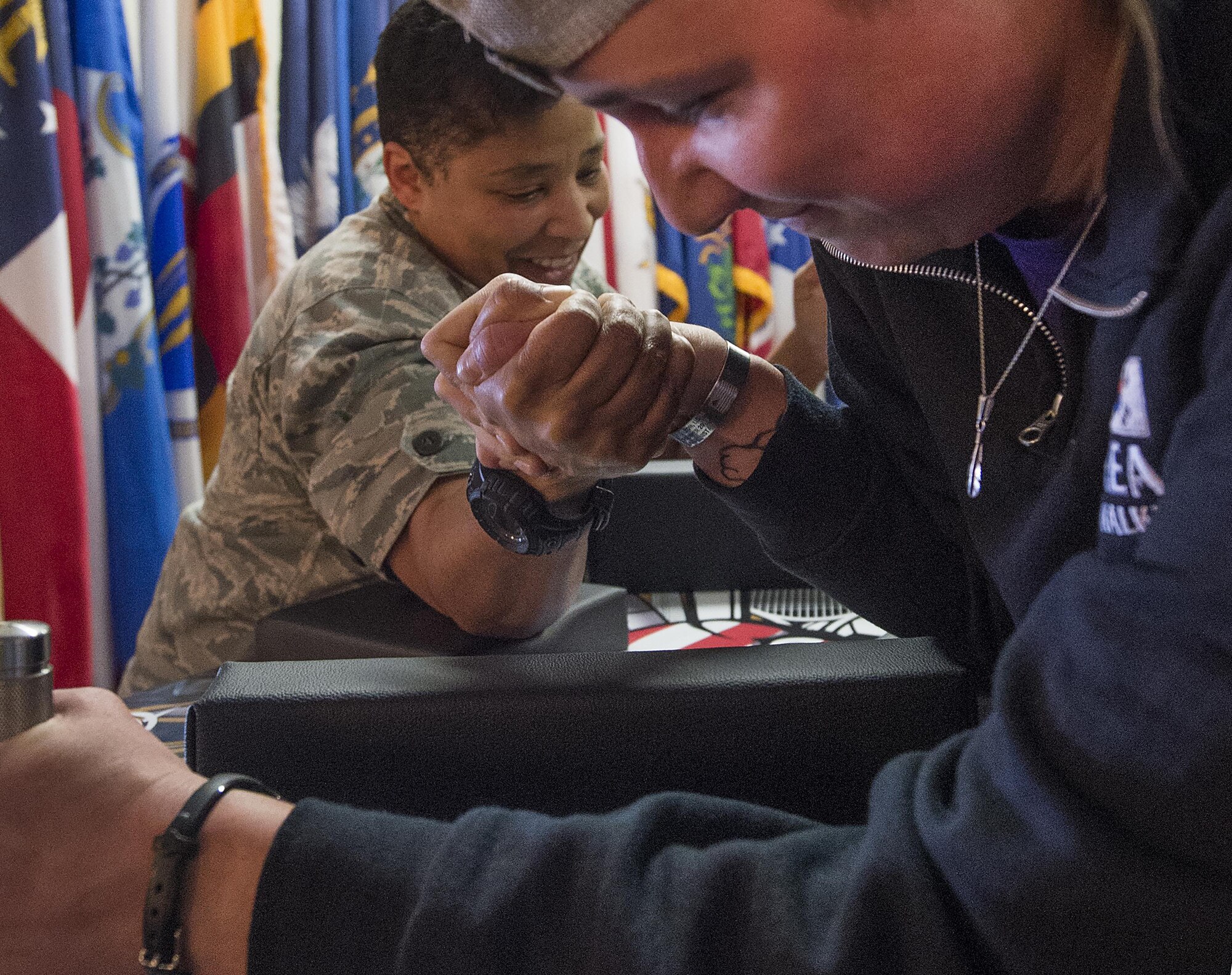 Katie Moorkamp takes down Michelle Stringer in an arm wrestling match April 1, 2016, at the Trail’s End Event Center’s grand reopening on F.E. Warren Air Force Base, Wyo. The center’s Wrangler Lounge will be open each weekend and other facilities can be booked for events. (U.S. Air Force photo by R.J. Oriez)