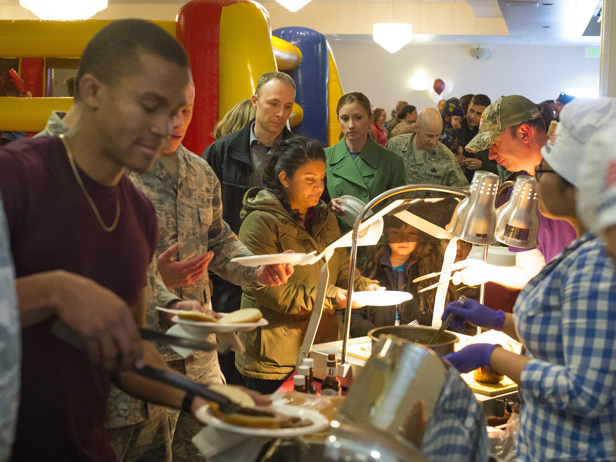 F.E. Warren Air Force Base, Wyo., Airman, families and retirees line up for a free burgers, hot dogs and buffalo meat April 1, 2016, during the grand reopening of the Trail’s End Event Center. The event center reopened after being closed for several months for refurbishing. (U.S. Air Force photo by R.J. Oriez)