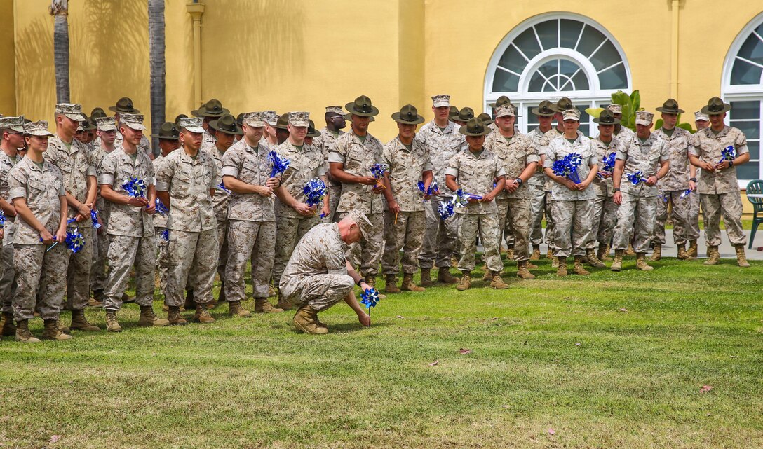 Colonel Mark M. Tull, chief of staff, Marine Corps Recruit Depot San Diego and the Western Recruiting Region, places the first pinwheel in the ground during a Pinwheels for Prevention event behind the Marine Corps Exchange here, April 5. This was the 3rd annual event on the depot in recognition of National Child Abuse Prevention Month.