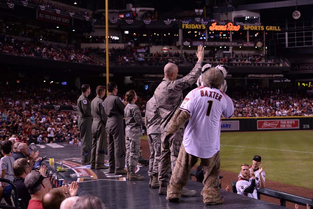 A crew of Airmen from the 62nd Fighter Squadron is presented to the crowd of the Arizona Diamondbacks’ season opener for successfully conducting a flyover with two F-35 Lightning II Joint Strike Fighters just before the start of the game on April 4th, 2016, at Chase Field ballpark in Phoenix, Ariz. The 62nd Fighter Squadron flies out of Luke Air Force Base. (U.S. Air Force photo by Airman 1st Class Ridge Shan)