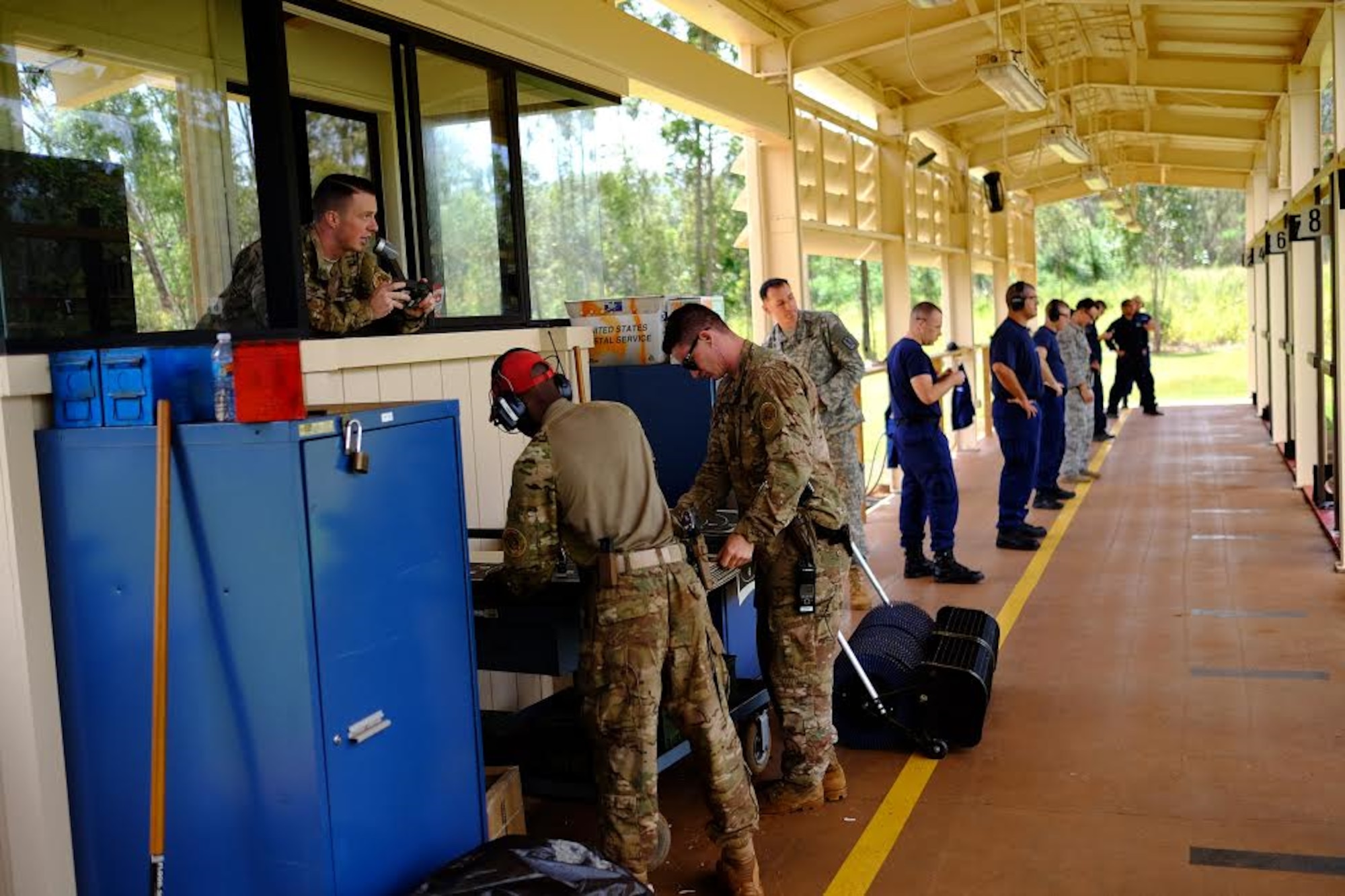 Staff Sgt. Jordan Locke, 647th Security Forces Squadron Combat Arms instructor, provides instructions during the Excellence in Competition pistol event, held 29-31 March, at the 647th SFS Combat Arms Firing Range on Schofield Barracks. (U.S. Air Force photo by Staff Sgt. Christopher Stoltz/Released)