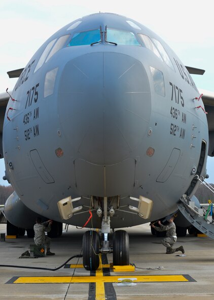 Staff Sgt. Matthew Calvo, 736th Aircraft Maintenance Squadron communication, counter-measure and navigation system craftsman, left, and Airman 1st Class Adam Schad, 736th AMXS communication, counter-measure and navigation system apprentice, upload flares onto a C-17A Globemaster III March 25, 2016, at Dover Air Force Base, Del. Flares are uploaded into several  magazine wells that are strategically placed throughout the aircraft. (U.S. Air Force photo/Senior Airman William Johnson)