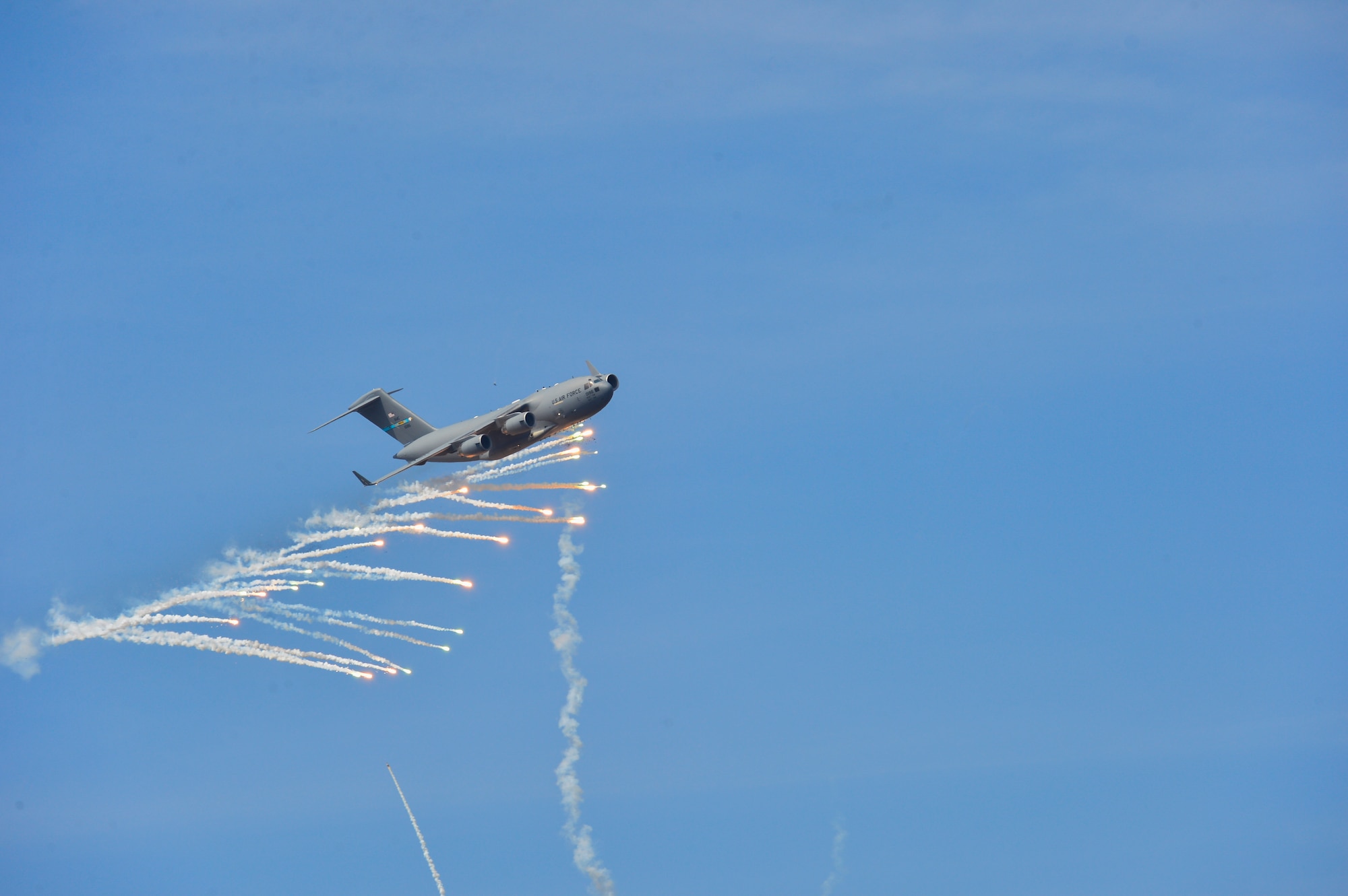 A Dover C-17A Globemaster III expends countermeasure flares to defeat a simulated surface-to-air missile, or smokey SAM, shot from a Man-Portable Aircraft Survivability Trainer system during a training mission March 24, 2016, at the Bollen Live-Fire Range Complex on Fort Indiantown Gap, Pa. A total of 240 flares were expended for the aircraft during the training mission. (U.S. Air Force photo/Senior Airman William Johnson)