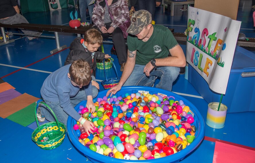 Members of the Minot Youth Center dig through Easter eggs at Minot Air Force Base, N.D., March 25, 2016. At the Easter Eggstravaganza, kids could hunt for the golden egg, play different Easter themed games and take a stroll through Candyland. (U.S. Air Force photo/Airman 1st Class Christian Sullivan)