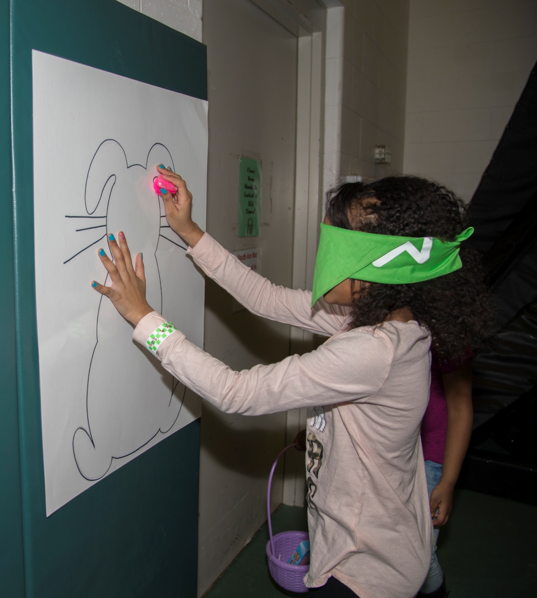 A Minot Youth Center member participates in pin the cotton tail game on the Easter Bunny during the Youth Center’s Easter Eggstravaganza at Minot Air Force Base, N.D., March 25, 2016. At the event, kids could hunt for the golden egg, play different Easter themed games and take a stroll through Candyland. (U.S. Air Force photo/Airman 1st Class Christian Sullivan)