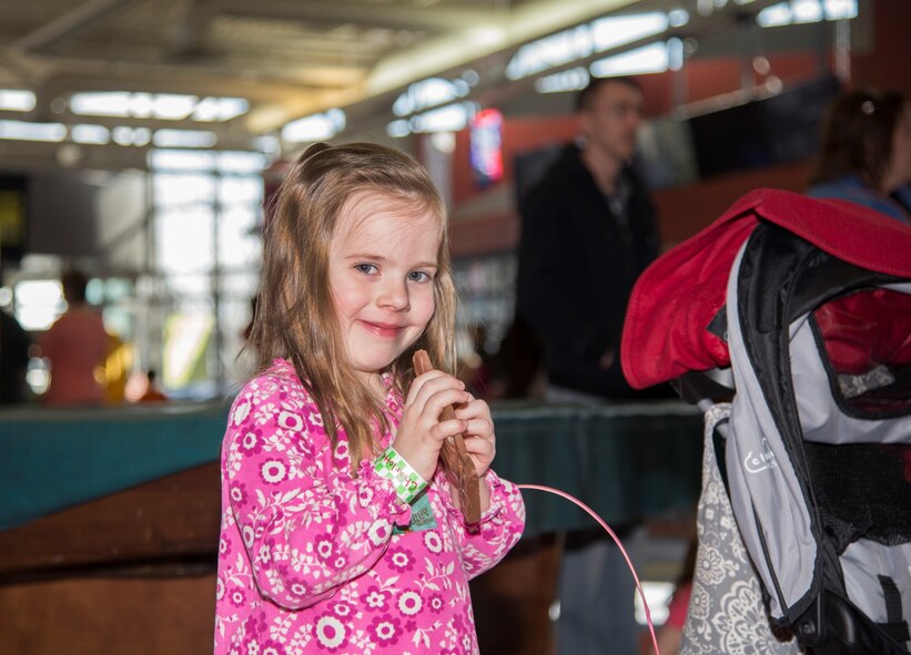 A Minot Youth Center member enjoys a piece of candy at Minot Air Force Base, N.D., March 25, 2016. Free candy was one of the many perks of the Easter Eggstravaganza. (U.S. Air Force photo/Airman 1st Class Christian Sullivan)
