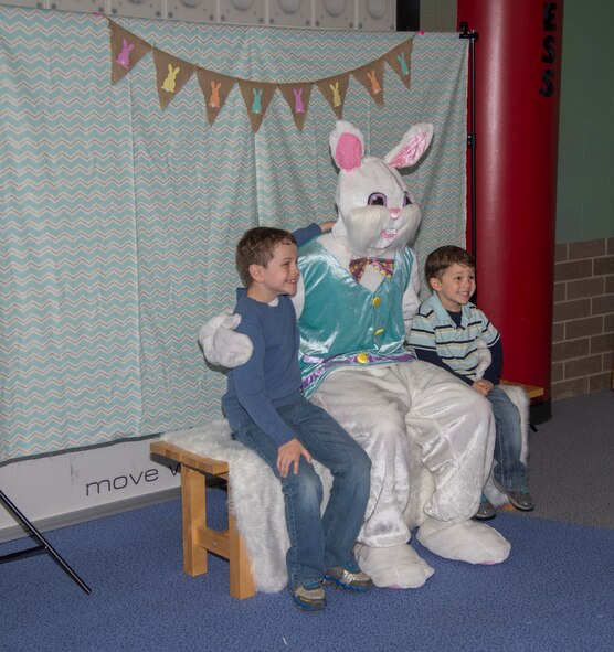 Minot Youth Center members sit with the Easter Bunny at Minot Air Force Base, N.D., March 25, 2016. Easter Bunny photos were one of many features offered by the Youth Center during their Easter Eggstravaganza event. (U.S. Air Force photo/Airman 1st Class Christian Sullivan)