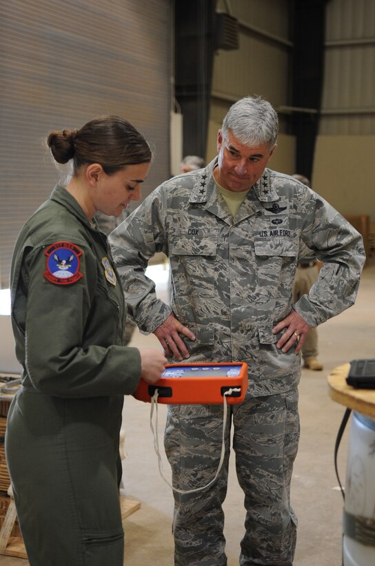 U.S. Air Force Senior Airman Samantha Masten, 39th Airlift Squadron loadmaster, talks with Lt. Gen. Sam Cox, 18th Air Force commander, about the different types of pallets that are bundled and dropped from the C-130J Super Hercules, March 29, 2016, at Dyess Air Force Base, Texas. While visiting Dyess, Cox toured the 317th Operation Support Squadron, Child Development Center, Deployment Readiness center, C-130J simulator and had lunch with award winners, non-commissioned officers and officers assigned to the 317th Airlift Group. (U.S. Air Force photo by Senior Airman Shannon Hall/Released)