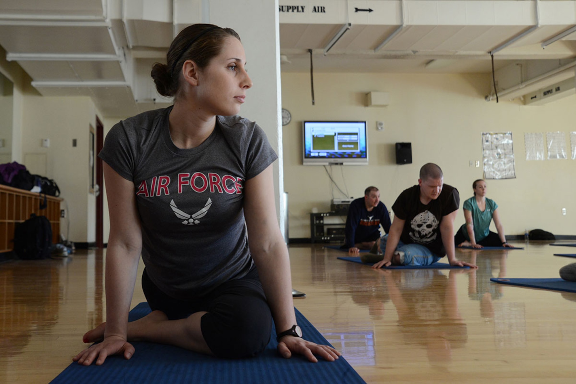 Airman 1st Class Nicole Rent, 703d Aircraft Maintenance Squadron aerospace maintenance apprentice, stretches in a PiYo class at the Elmendorf Fitness Center, Joint Base Elmendorf-Richardson, Alaska, March 22, 2016. Exercising while pregnant is helpful because it increases energy, improves mood, and muscle tone. (U.S. Air Force photo by Airman 1st Class Christopher R. Morales)