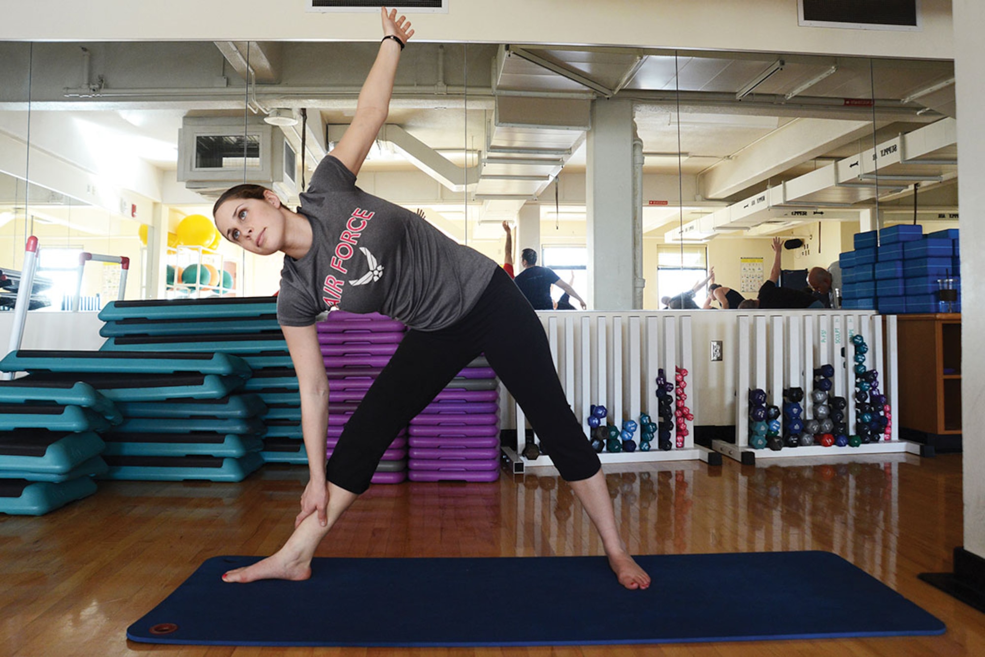 Airman 1st Class Nicole Rent, 703d Aircraft Maintenance Squadron aerospace maintenance apprentice, stretches in a PiYo class at the Elmendorf Fitness Center, Joint Base Elmendorf-Richardson, Alaska, March 22, 2016. Exercising while pregnant is helpful because it promotes better posture, improves endurance, and reduces backache. (U.S. Air Force photo by Airman 1st Class Christopher R. Morales)