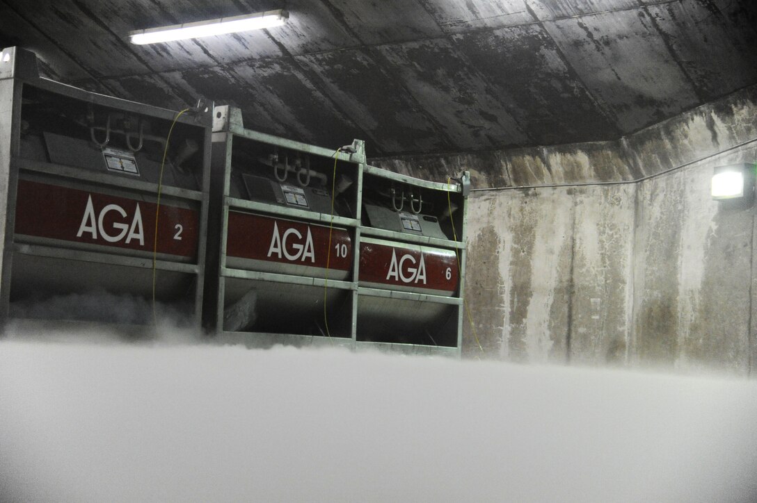 Condensation from liquid oxygen tanks hits the air and freezes inside in a hardened aircraft shelter at Keflavik International Airport, Iceland, April 2, 2016. Electro-environmental technicians assigned to the 104th Maintenance Group, Barnes Air National Guard Base, Mass., transfer the oxygen into portable units that can replenish oxygen supplies in aircraft. Four U.S. Air Force F-15C Eagle fighter aircraft, assigned to the 104th Fighter Wing, deployed to Keflavik, Iceland, to support Icelandic Air Surveillance operations throughout April. (U.S. Air Force photo by Master Sgt. Kevin Nichols/Released)