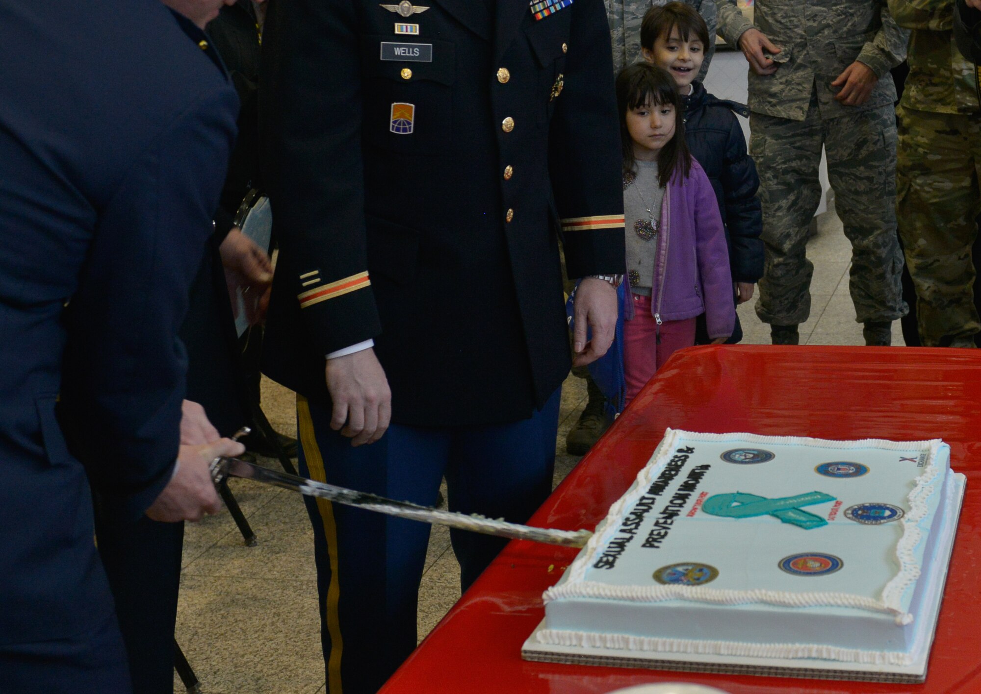 U.S Air Forces in Europe leaders cut a cake during the Sexual Assault Resource Center opening ceremony cake April 1, 2016, at Ramstein Air Base, Germany. The ceremonial cake cutting kicked off this year’s Sexual Assault and Awareness Prevention month at the Kaiserslautern Military Community Center and hosted service members and their dependents from the U.S. Air Force and Army. (U.S. Air force photo/Airman 1st Class Lane T. Plummer)