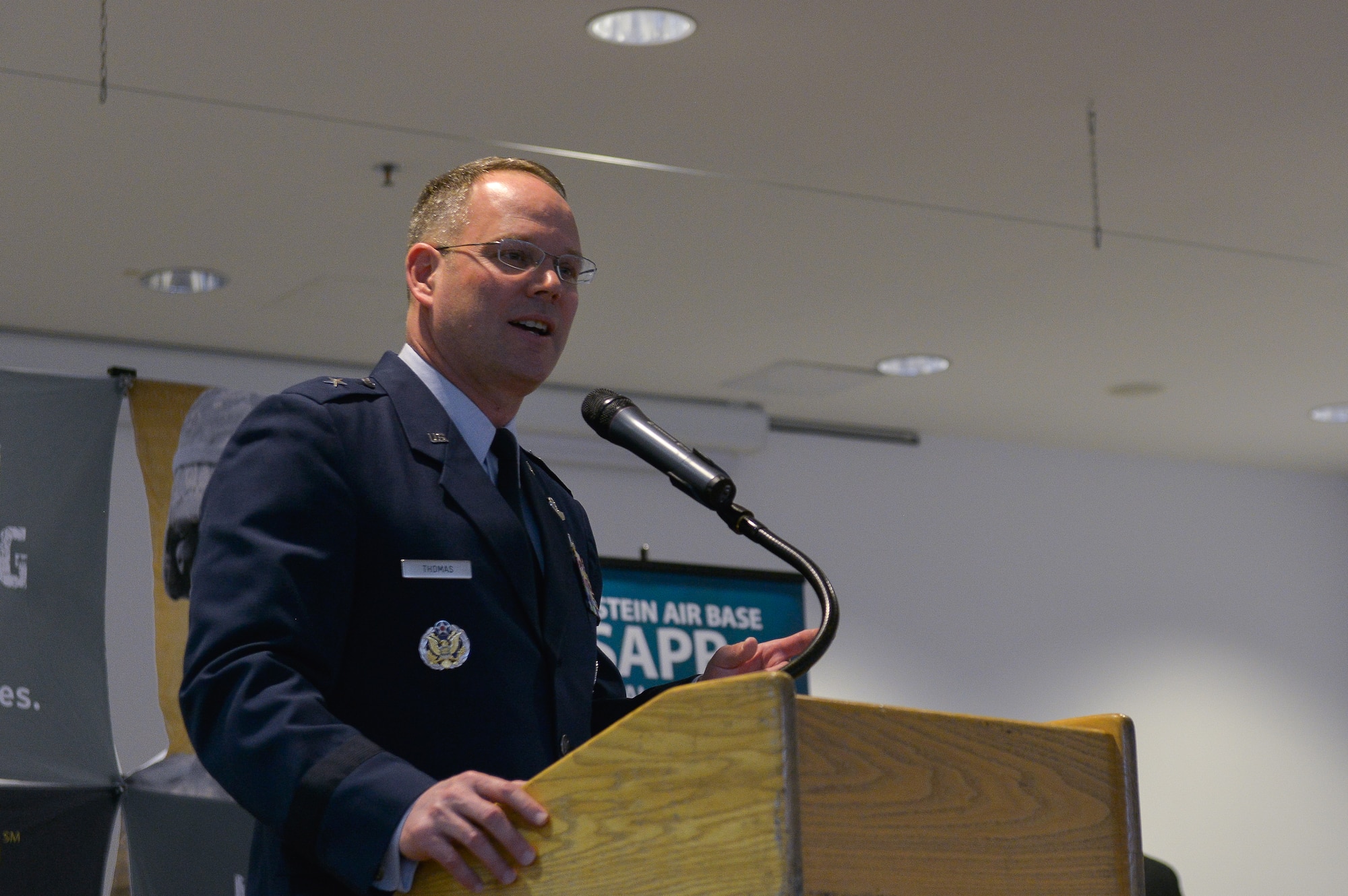 Brig. Gen. Jon T. Thomas, 86th Airlift Wing commander, speaks to a crowd of people attending the Sexual Assault Resource Center opening ceremony April 1, 2016, at Ramstein Air Base, Germany. The ceremony kicked off this year’s Sexual Assault Awareness and Prevention month and allowed U.S. Air Forces in Europe leaders to speak about the importance and meaning of the SARC. (U.S. Air force photo/Airman 1st Class Lane T. Plummer)