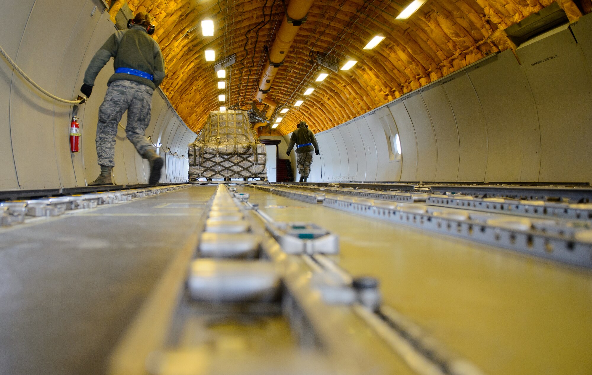 Airmen from the 721st Aerial Port Squadron, part of the 521st Air Mobility Operations Wing, move the last pallet of 40 brought by a KC-10 Extender at Ramstein Air Base, Germany, March 25, 2016. Airmen from the 721st APS helped process and move food to children in need living in Afghanistan. (U.S. Air Force photo/Staff Sgt. Armando A. Schwier-Morales)