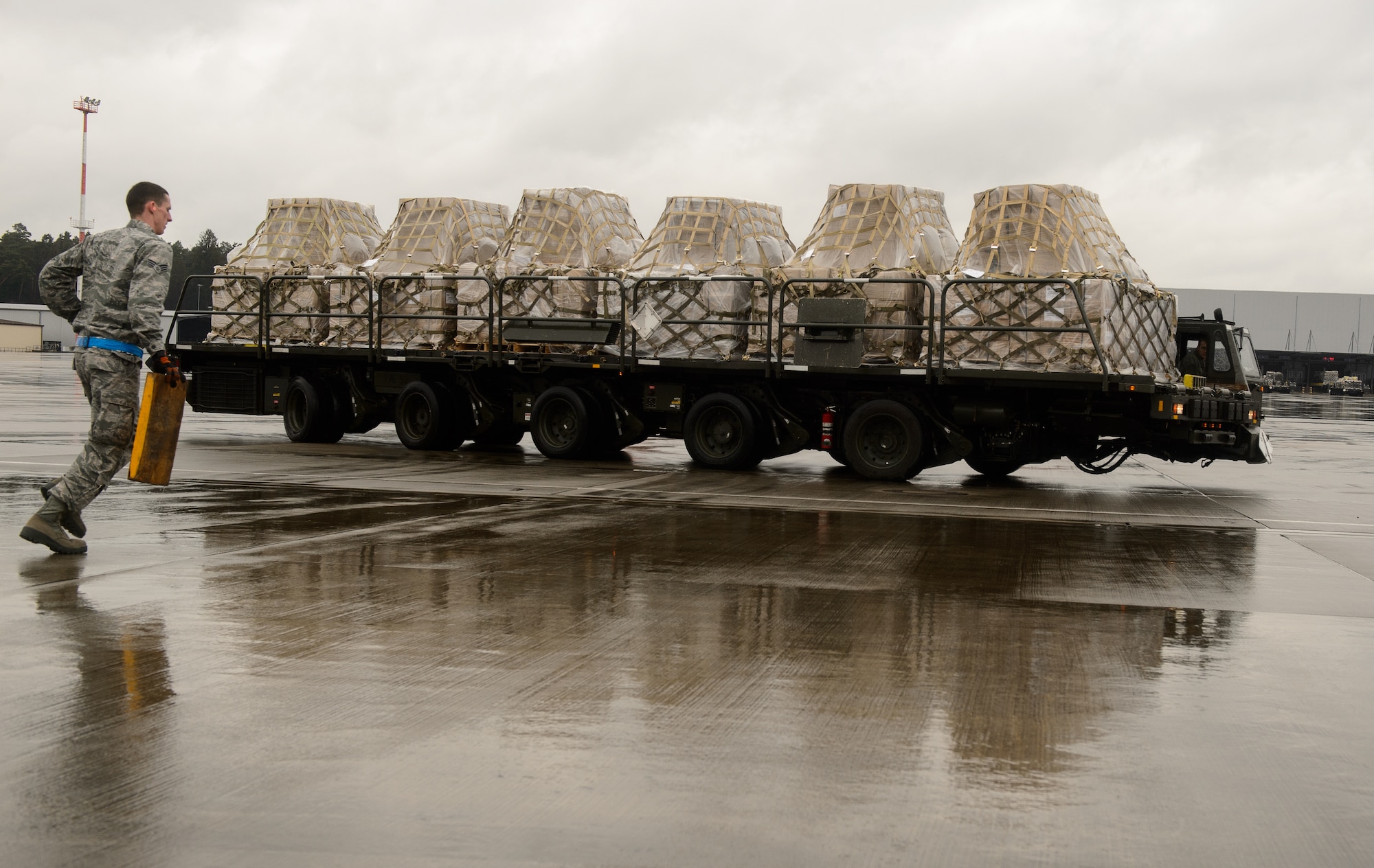 Airmen from the 721st Aerial Port Squadron, part of the 521st Air Mobility Operations Wing, move cargo at Ramstein Air Base, Germany, March 25, 2016. Airmen helped process and move food to children in need living in Afghanistan. (U.S. Air Force photo/Staff Sgt. Armando A. Schwier-Morales)