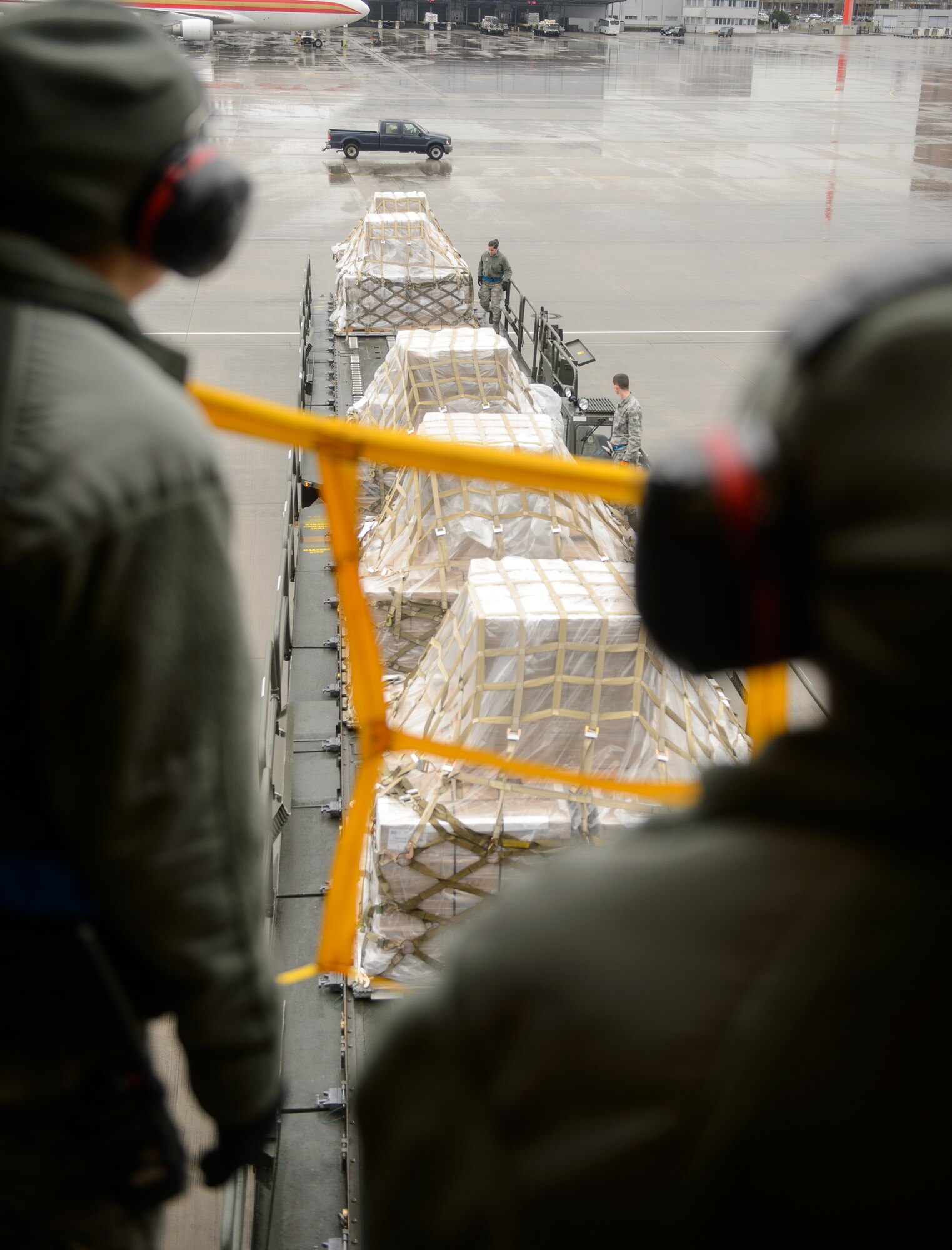 Ramp specialists from the 721st Aerial Port Squadron ensure cargo is transferred properly March 25, 2016, at Ramstein Air Base, Germany. A team of Airmen from the Air Force Reserve and active duty 721st APS ensured more than 40 pallets of food were safely off-loaded and transferred in order to reach their final destination in Afghanistan. (U.S. Air Force photo/Staff Sgt. Armando A. Schwier-Morales)