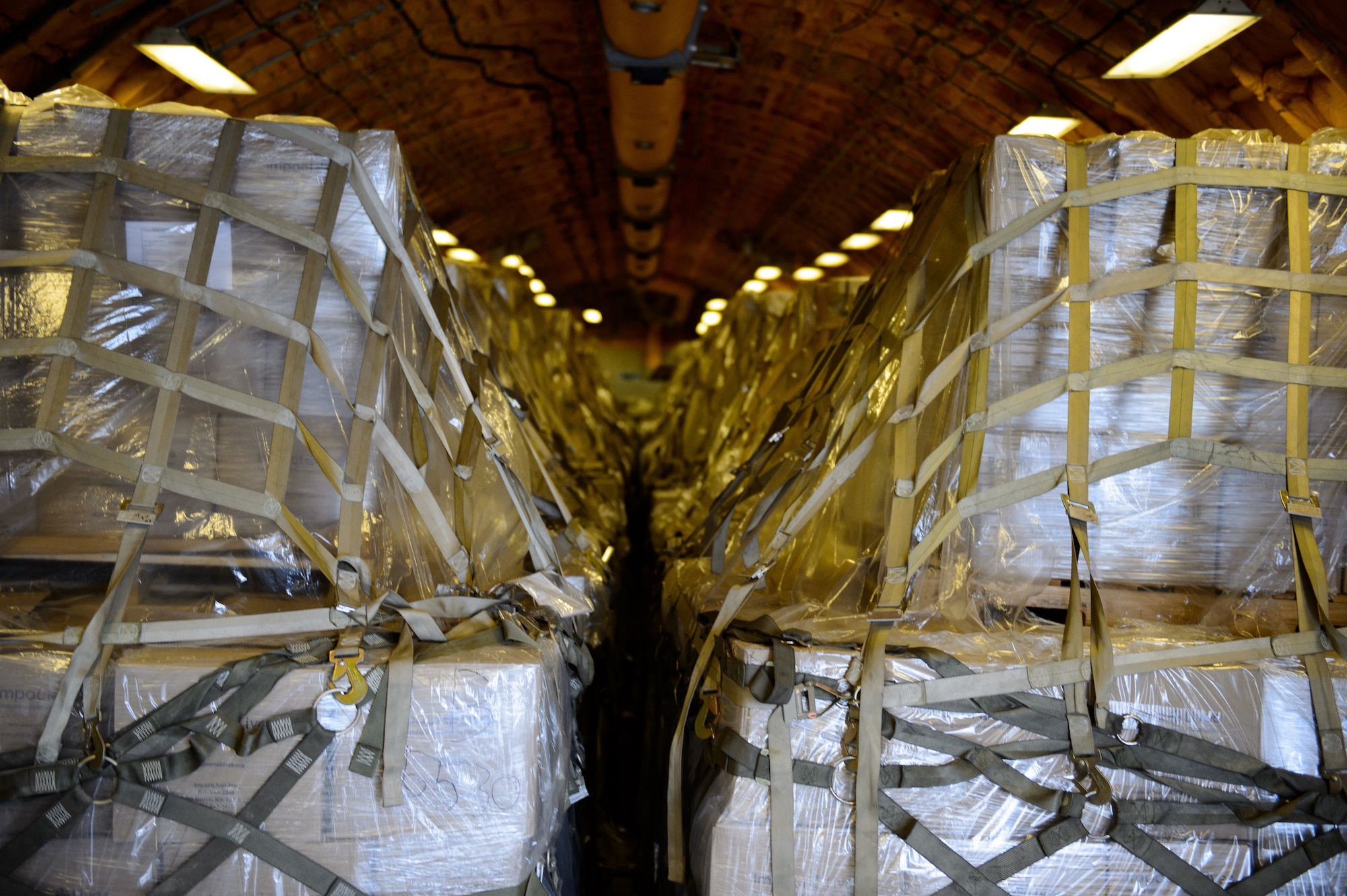 Cargo pallets wait as Airmen from the 521st Air Mobility Operations Wing offload them from a KC-10 Extender March 25, 2016, at Ramstein Air Base, Germany. Cargo regularly flows through Ramstein’s ramps however the load brought by the KC-10 was to provide meals for children in need. (U.S. Air Force photo/Staff Sgt. Armando A. Schwier-Morales)