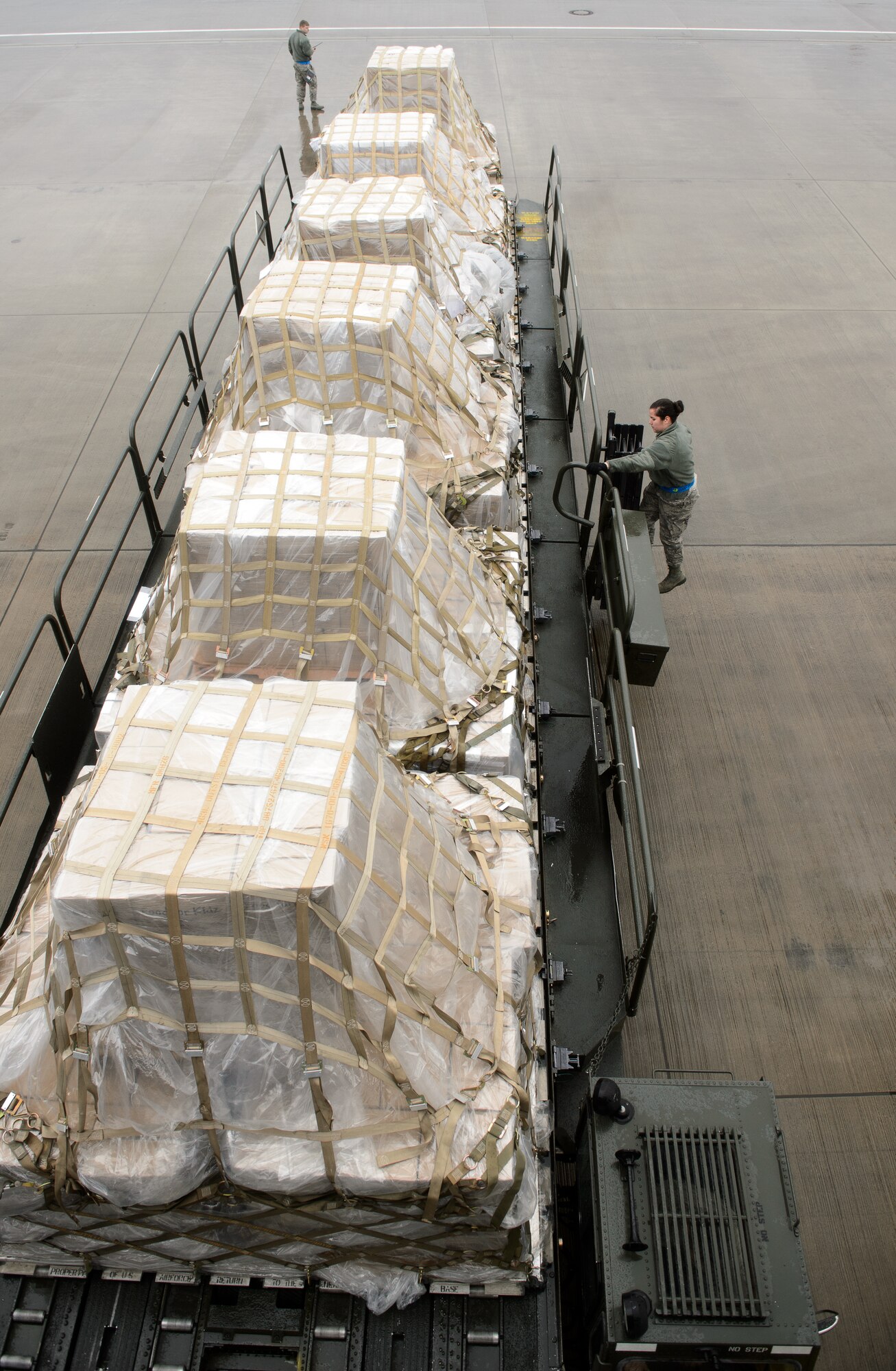 Airmen from the 721st Aerial Port Squadron move humanitarian cargo March 25, 2016, at Ramstein Air Base, Germany. A KC-10 Extender from the 76th Air Refueling Squadron brought the cargo to Germany as part of a training mission they were doing. Once at Ramstein, 721st APS Airmen will coordinate to get more than 285,000 meals to children in need. (U.S. Air Force photo/Staff Sgt. Armando A. Schwier-Morales)