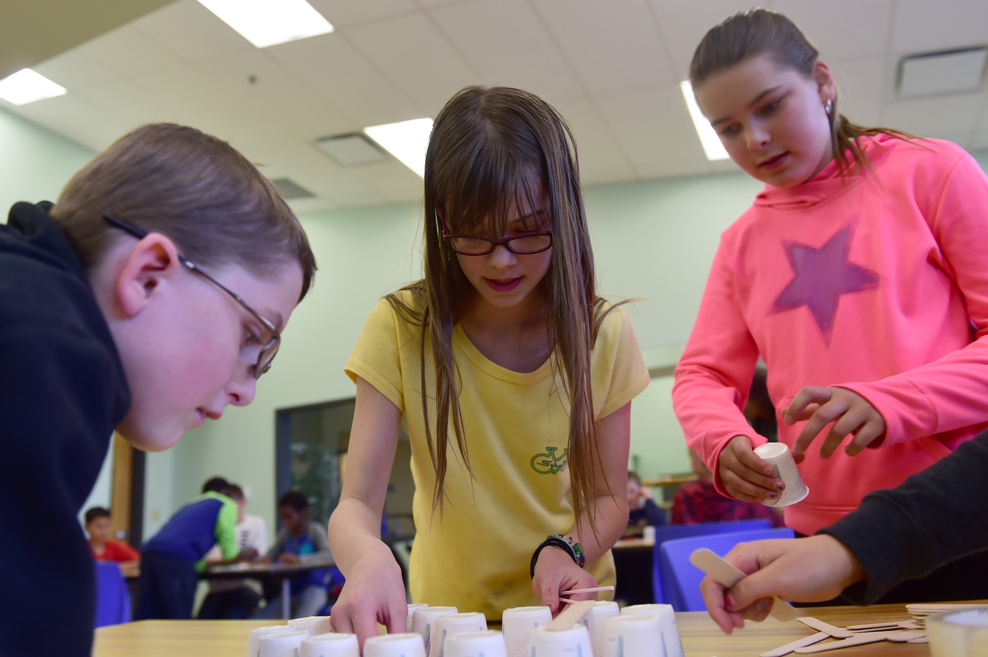 A STEM (Science, Technology, Engineering and Math) Camp team works together to complete an assigned task March 31, 2016, at the youth center on Buckley Air Force Base, Colo. The teams were asked to build a structure that could hold in a simulated oil spill. (U.S. Air Force photo by Airman 1st Class Luke W. Nowakowski/Released)