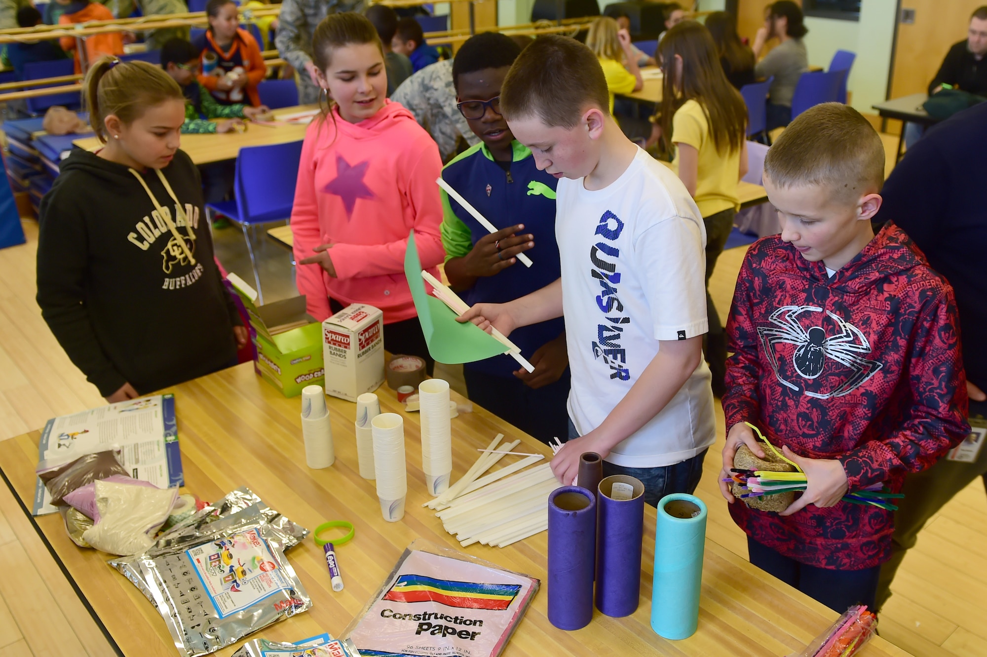 Children gather up supplies to complete a STEM (Science, Technology, Engineering and Math) Camp objective March 31, 2016, at the youth center on Buckley Air Force Base, Colo. Buckley AFB in conjunction with Colorado State University put on this interactive learning camp to get local children involved in the sciences. (U.S. Air Force photo by Airman 1st Class Luke W. Nowakowski/Released)