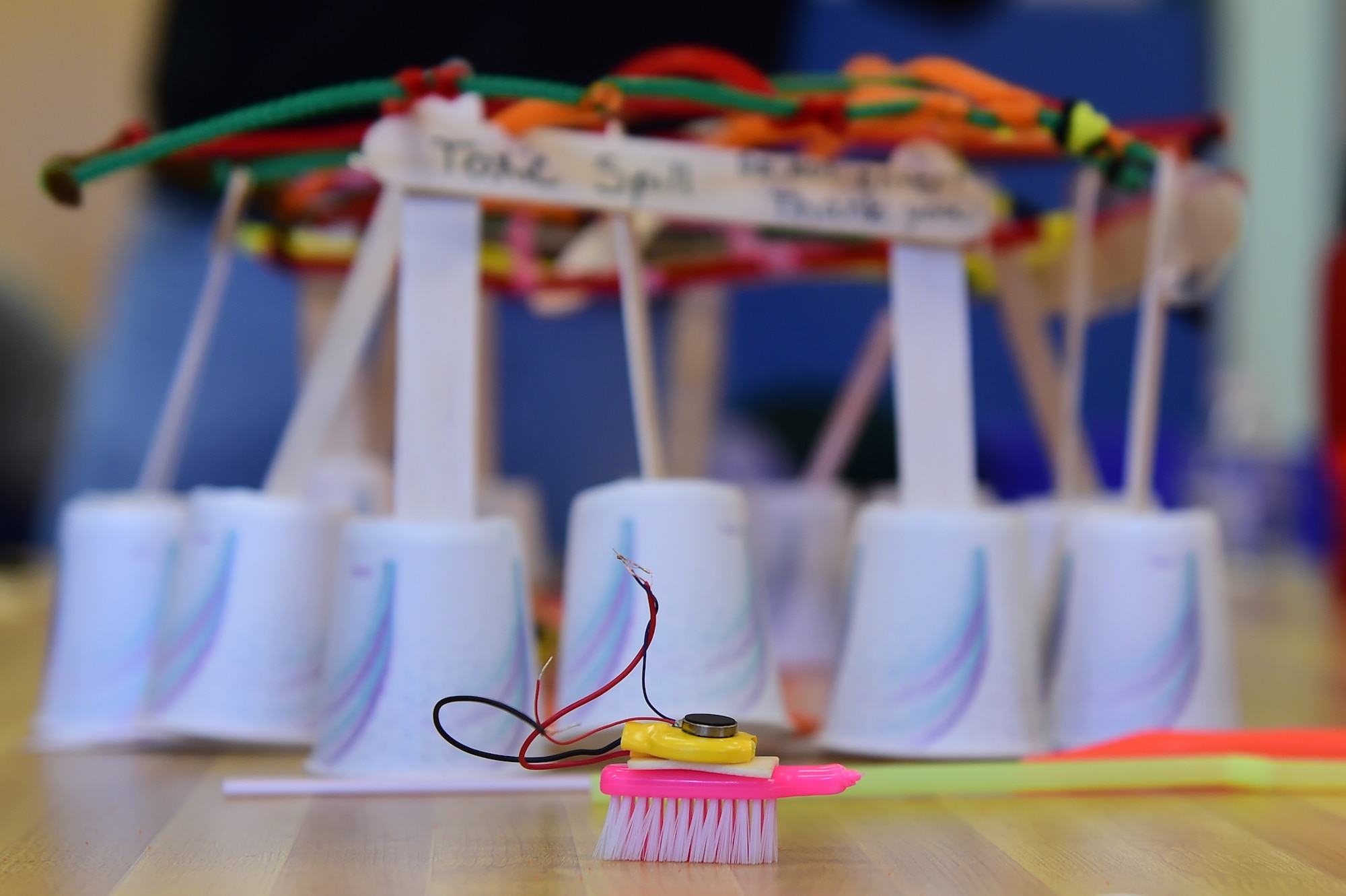 A toothbrush is converted into a robotic cleaning device used to clean up a simulated oil spill during STEM (Science, Technology, Engineering and Math) Camp March 31, 2016, at the youth center on Buckley Air Force Base, Colo. This was the first year Buckley AFB held STEM Camp with help from Colorado State University. (U.S. Air Force photo by Airman 1st Class Luke W. Nowakowski/Released)