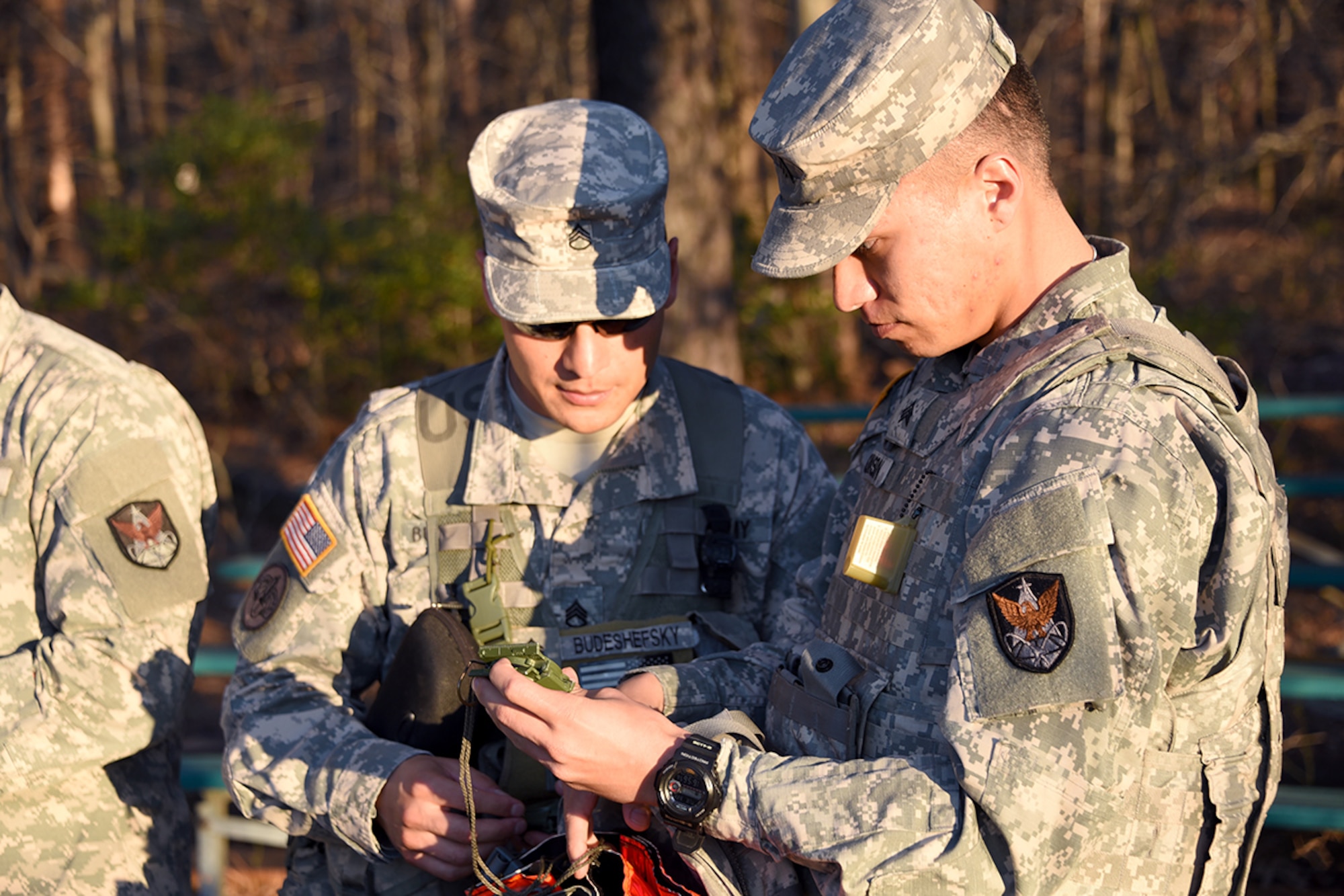 FORT MEADE, Md. – Staff Sgt. Christian Budeshefsky, Headquarters and Headquarters Company, 1st Space Battalion, left, and Sgt. Steven Johnson, Headquarters and Headquarters Company, 53rd Signal Battalion, check their equipment and talk about the impending night land navigation course on March 22 during the U.S. Army Space and Missile Defense Command/Army Forces Strategic Command’s Eastern Region Best Warrior Competition March 21-24 at Fort Meade, Maryland. Johnson was named the Eastern Region’s Noncommissioned Officer Best Warrior. (Photos by Carrie E. David )