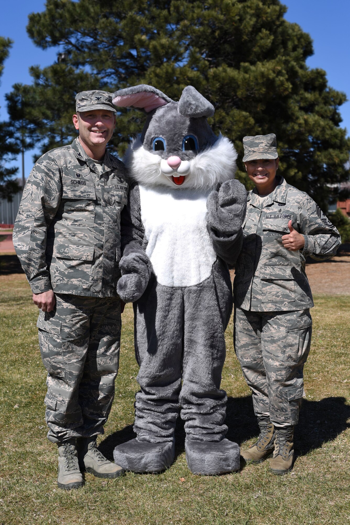 PETERSON AIR FORCE BASE, Colo. - Col. Douglas A. Schiess, 21st Space Wing commander, and Chief Master Sgt. Idalia A. Peele, 21st Space Wing command chief, hung out with the Easter Bunny during the 21st Force Support Squadron’s Egg-stravaganza at the Capt. David Lyon Memorial Park at Peterson Air Force Base on April 2, 2016. The Easter bunny made a special appearance and handed out candy and hugs to all the children. (U.S. Air Force photo by Airman 1st Class Dennis Hoffman)