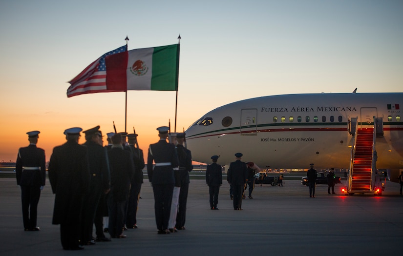 Joint Color Guard members stand at attention during the Mexican Presidential arrival on the Joint Base Andrews flightline, March 31, 2016. More than 20 countries are scheduled to arrive for the 2016 Nuclear Security Summit held in Washington, D.C. The summit provides a forum for leaders to reinforce commitments to securing nuclear materials. (U.S. Air Force photo by Staff Sgt. Chad C. Strohmeyer/RELEASED)