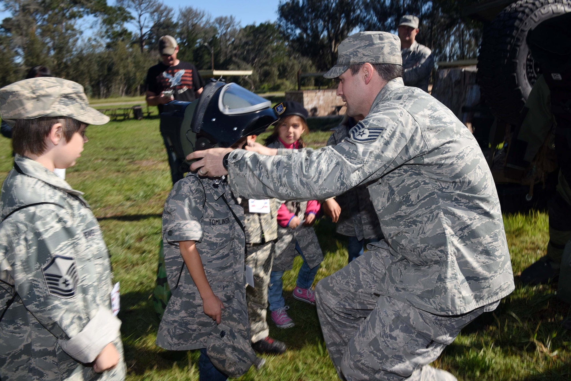 Staff Sgt. Thane Adams, 30th Civil Engineer Squadron explosive ordnance disposal specialist, demonstrates the EOD-9 bomb suit during Kids Understanding Deployment Operations, March 29, 2016, Vandenberg Air Force Base, Calif. KUDOS is a program developed to give children a deeper understanding of the military deployment process and equipment utilized during a deployment. (U.S. Air Force photo by Staff Sgt. Jim Araos/Released)