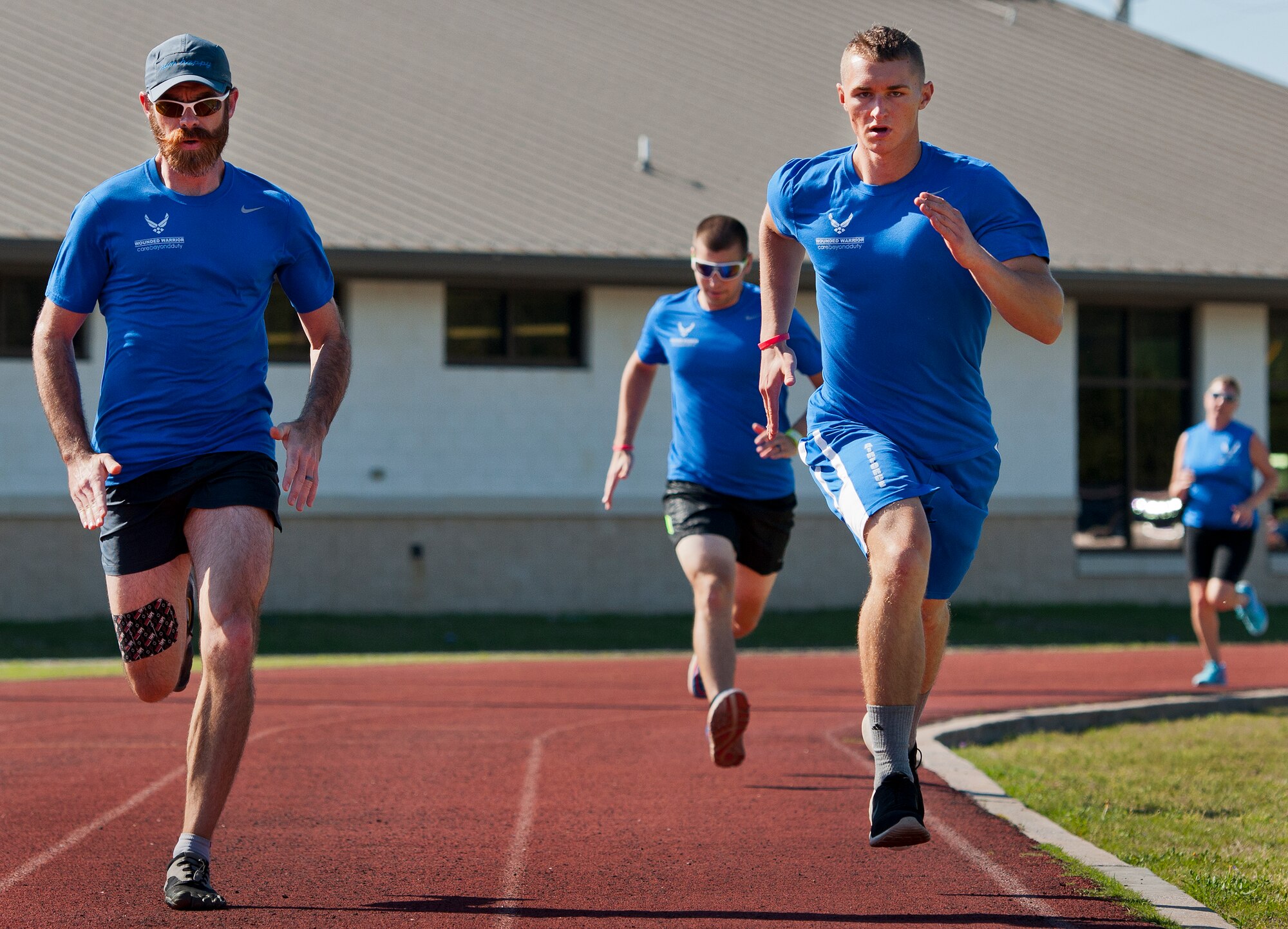 Shawn Schwantes and Cody Bakx, Warrior Games athletes, practice distance running during an afternoon track and field session at the Air Force team’s training camp at Eglin Air Force Base, Fla., April 4.  The base-hosted, week-long Warrior Games training camp is the last team practice session before the yearly competition in June.  (U.S. Air Force photo/Samuel King Jr.)