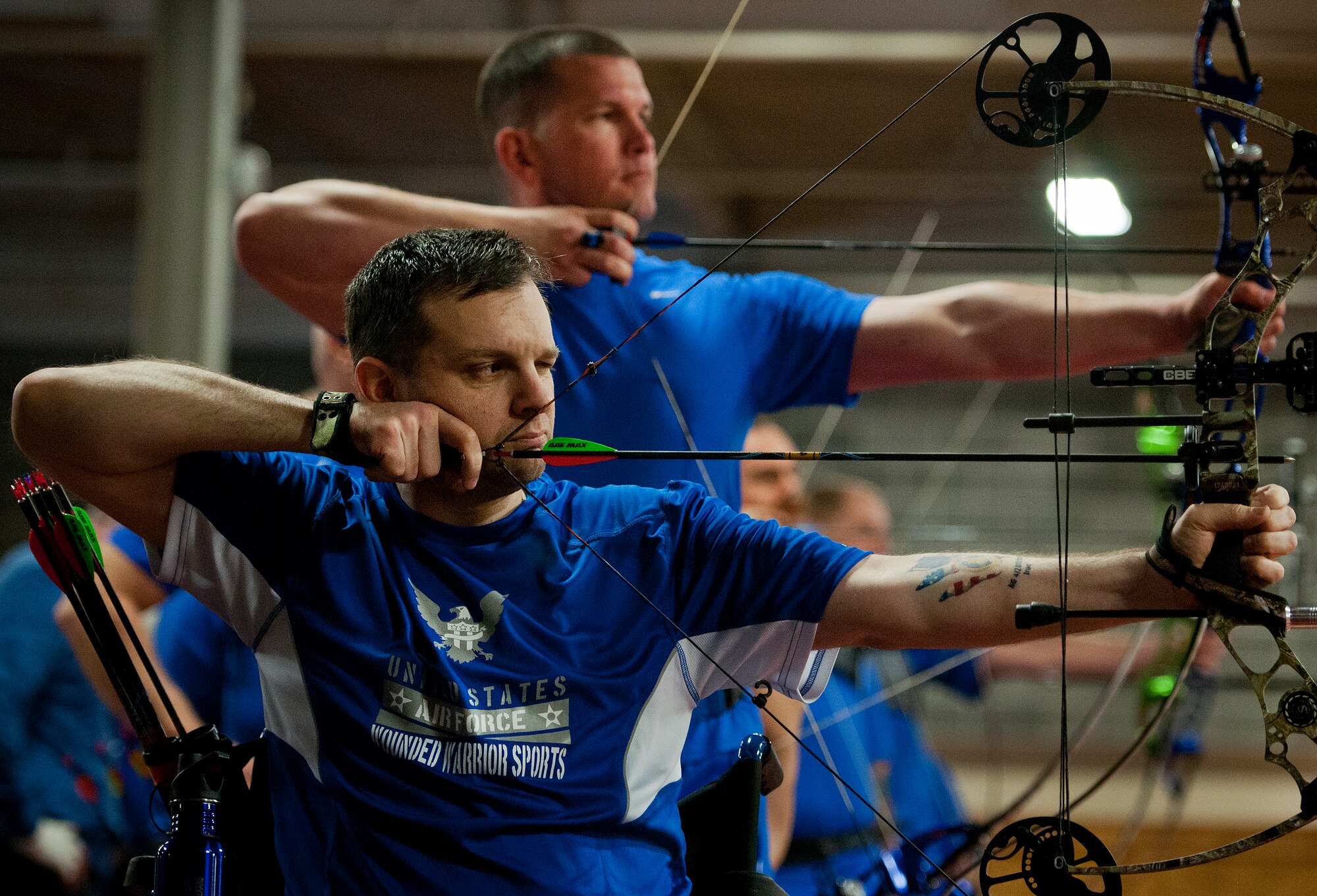 Brian Schaaf and Miguel Acevado, Warrior Games athletes, aim their arrows during a morning archery session at the Air Force team’s training camp at Eglin Air Force Base, Fla., April 4.  The base-hosted, week-long Warrior Games training camp is the last team practice session before the yearly competition in June.  (U.S. Air Force photo/Samuel King Jr.)