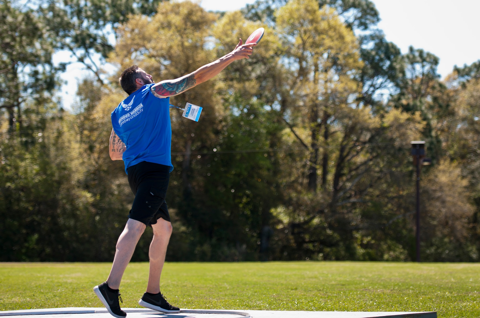 Dustin Goodwin, a Warrior Care attendee, throws the discus during a morning track and field session at the adaptive sports camp at Eglin Air Force Base, Fla., April 4.  The base hosts the week-long Wound Warrior CARE event that helps recovering wounded, ill and injured military members through specific hand-on rehabilitative training.  (U.S. Air Force photo/Samuel King Jr.)