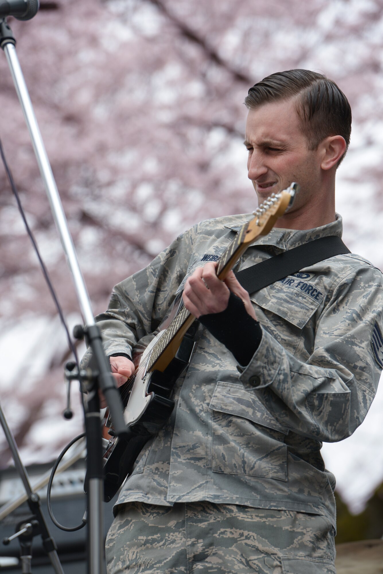 Staff Sgt. Aaron Weibe, Band of the Pacific-Asia guitarist, performs during the Sakura Spring Festival at Yokota Air Base, Japan, April 2, 2016. There were a variety of performances during the event, including Taiko drummers, dancers and bands. (U.S. Air Force photo by Staff Sgt. Cody H. Ramirez/Released)
