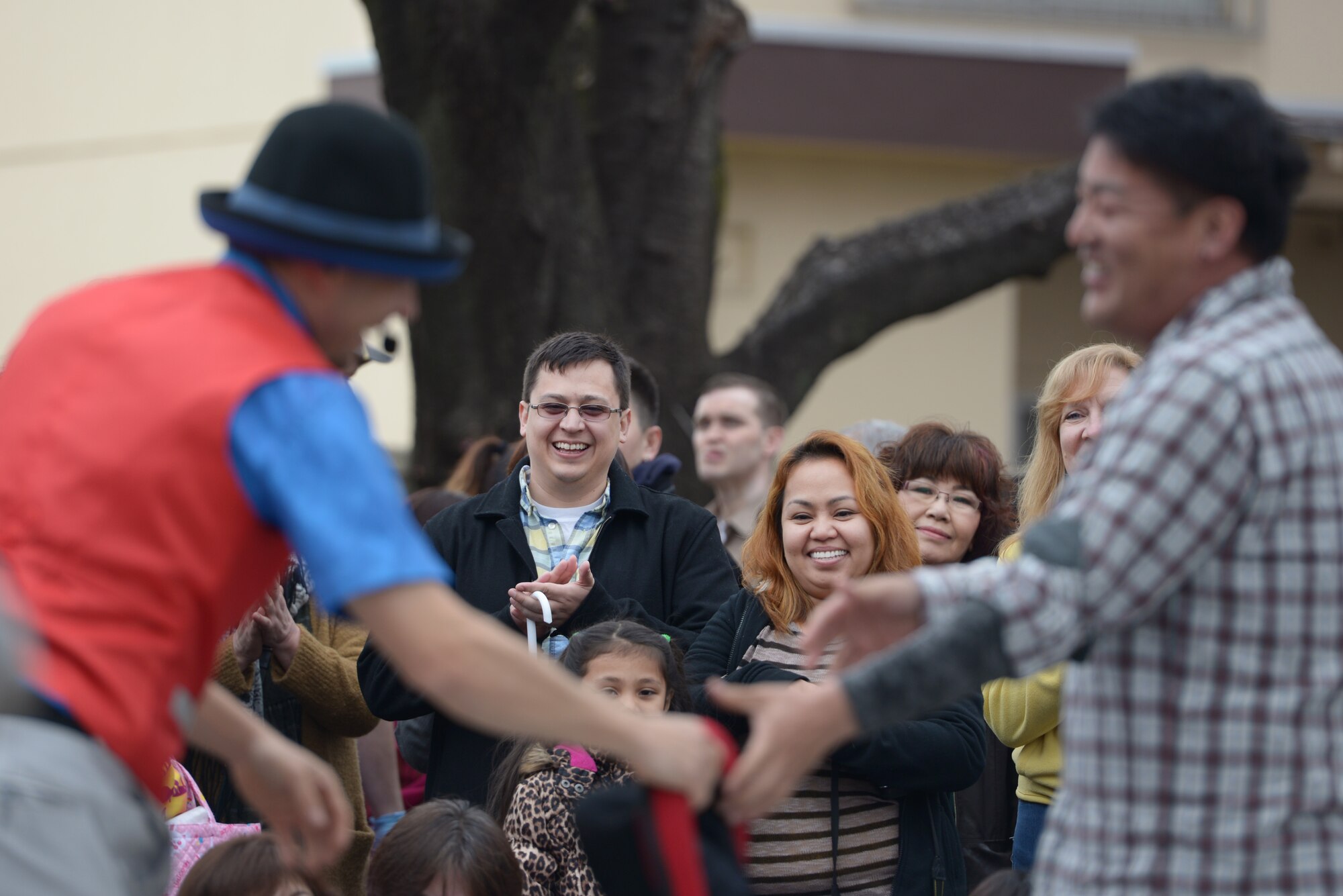 An audience watches a comedy routine during the Sakura Spring Festival at Yokota Air Base, Japan, April 2, 2016. The festival offered a variety of entertainment such as live performances and food booths to the approximate 5,000 attendees. (U.S. Air Force photo by Staff Sgt. Cody H. Ramirez/Released)