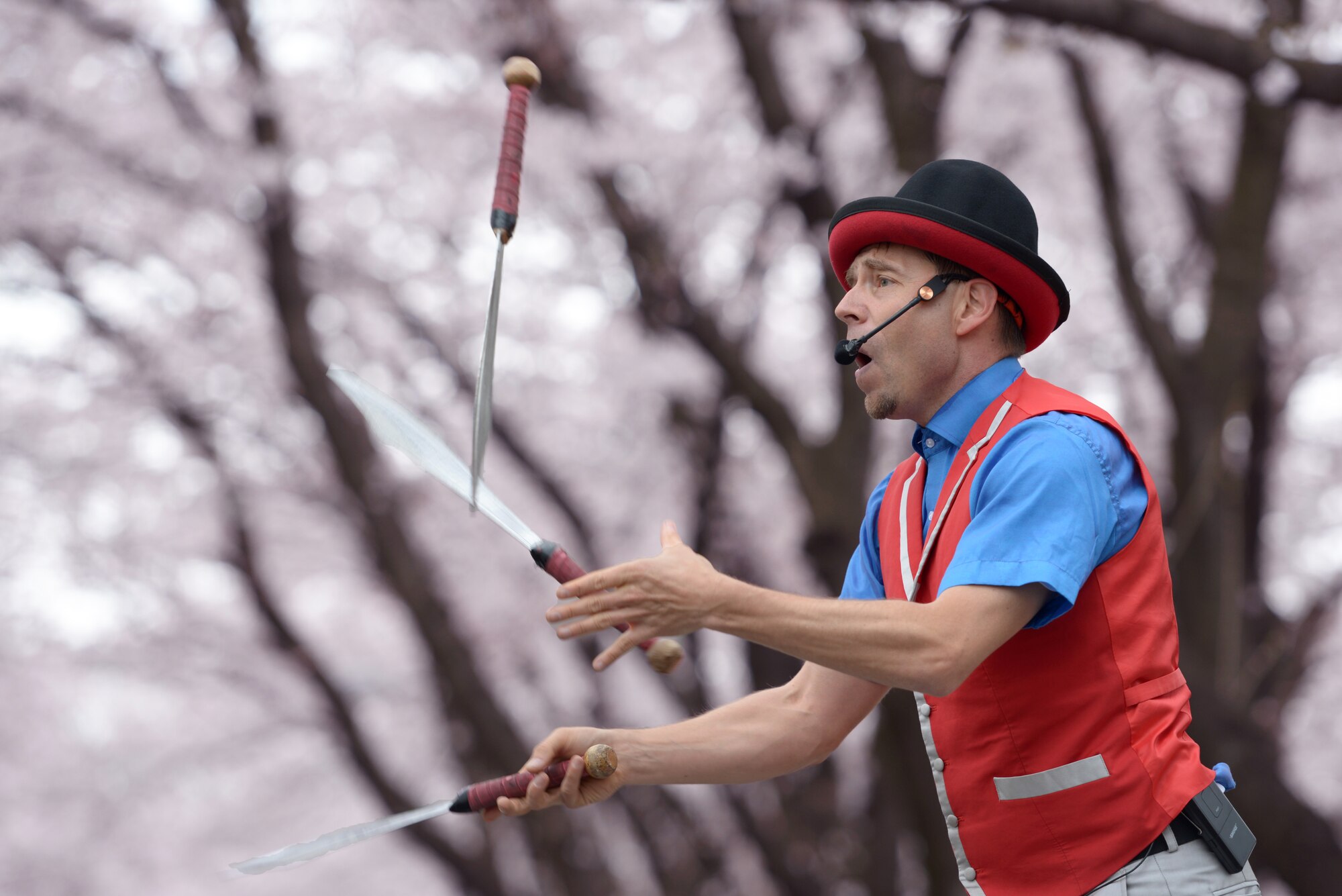 Banzai Mick, a comedy performer, juggles swords during the Sakura Spring Festival at Yokota Air Base, Japan, April 2, 2016. The festival offered a variety of entertainment such as live performances and food booths to the approximate 5,000 attendees. (U.S. Air Force photo by Staff Sgt. Cody H. Ramirez/Released)