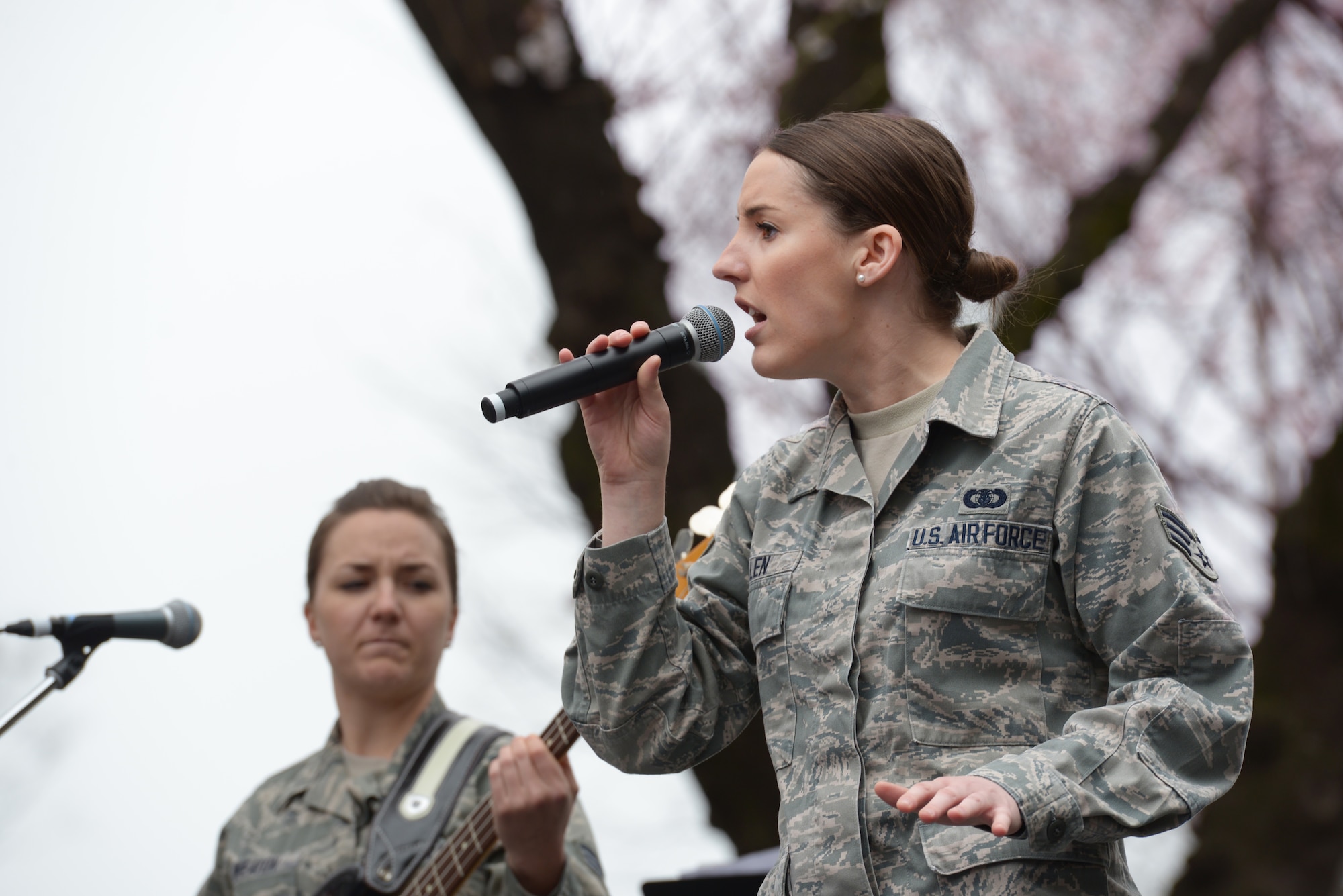 Senior Airmen Rebecca Allen (right) and Emily Wheaton (left), both members of the Band of the Pacific-Asia, perform during the Sakura Spring Festival at Yokota Air Base, Japan, April 2, 2016. The band performed a majority of American songs, introducing a U.S. culture experience to Japanese viewers, but they also played traditional Japanese songs, showing respect to their host-nation culture. (U.S. Air Force photo by Staff Sgt. Cody H. Ramirez/Released)
