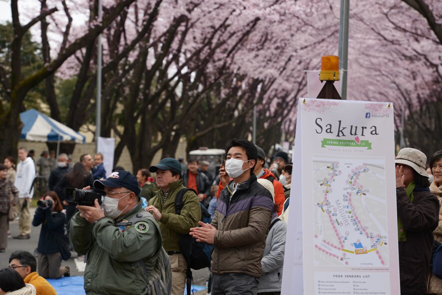 Festivalgoers watch the Band of the Pacific-Asia perform during the Sakura Spring Festival at Yokota Air Base, Japan, April 2, 2016. The festival consisted of band performances, dancers, Taiko drummers and food booths, offering a chance for Japanese citizens to experience American culture within the base’s perimeter. Approximately 5,000 people attended the event to celebrate the coming of spring. (U.S. Air Force photo by Staff Sgt. Cody H. Ramirez/Released)