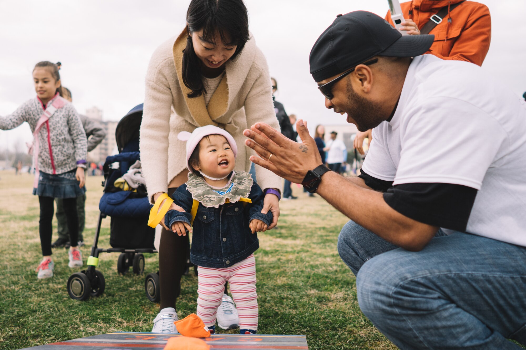 A Youth Festival volunteer cheers on a child during the Youth Festival at Yokota Air Base, Japan, April 3, 2016. In honor of the Month of the Military Child, the festival helped bring awareness to the contributions and sacrifices that service members' children make year round. (U.S. Air Force photo by Airman 1st Class Delano Scott/Released)