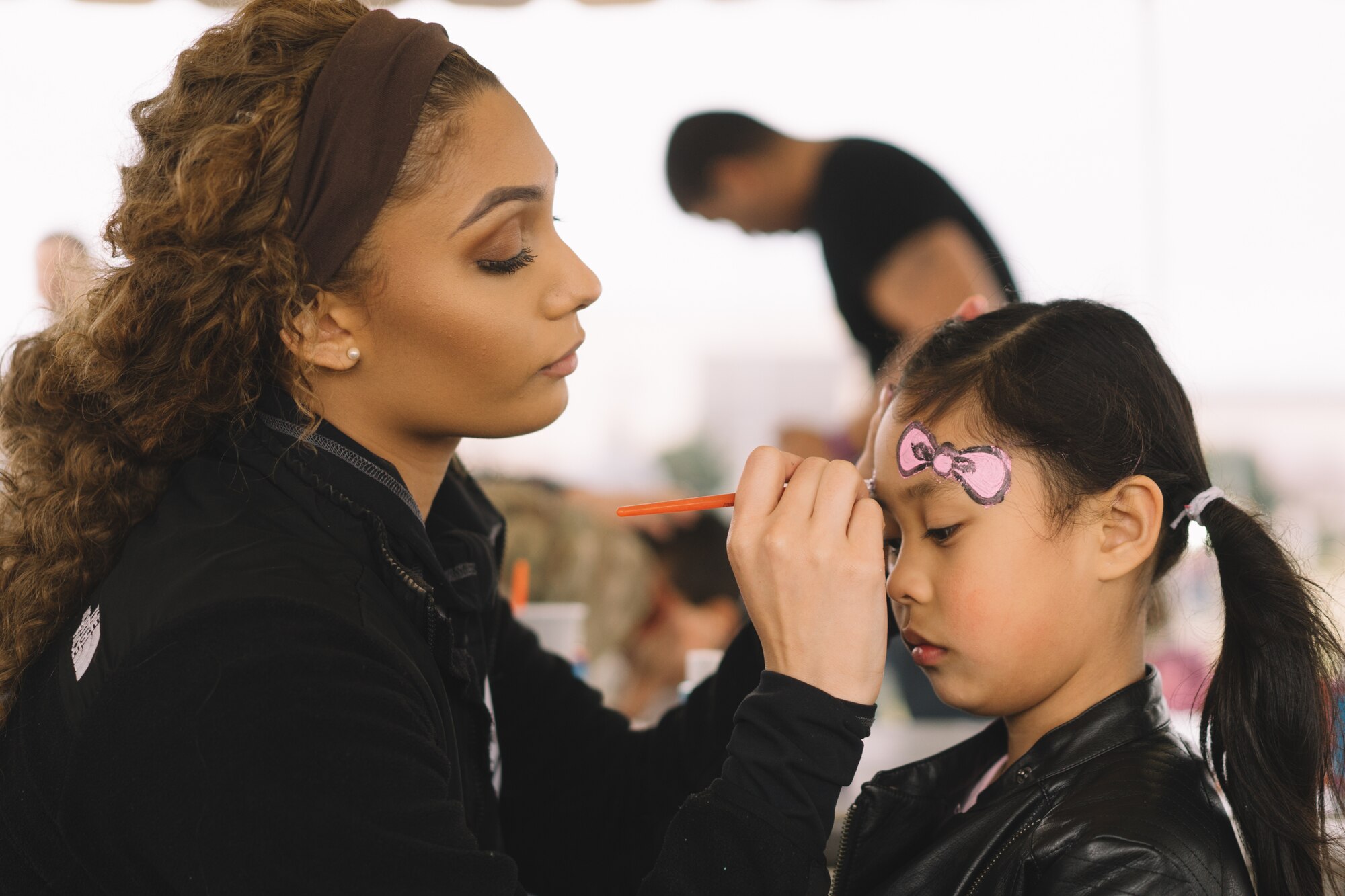 A child gets her face painted during the Youth Festival at Yokota Air Base, Japan, April 3, 2016. The festival offered Yokota members an opportunity to celebrate the Month of the Military Child with games, food and entertainment. (U.S. Air Force photo by Airman 1st Class Delano Scott/Released)