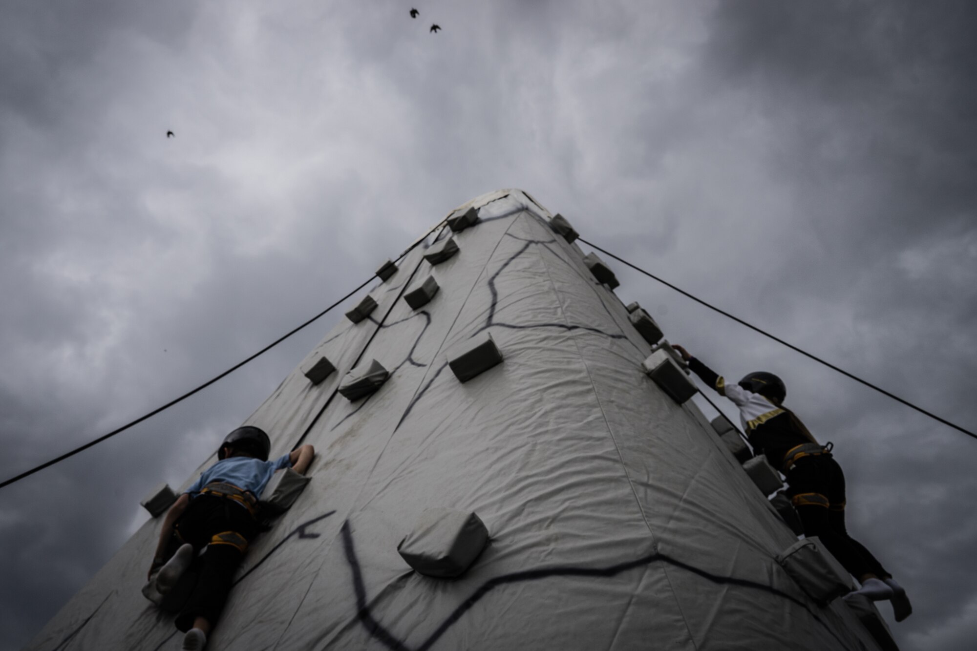 Children climb an inflatable mountain during the Youth Festival at Yokota Air Base, Japan, April 3, 2016. Yokota families gathered at the Samurai Field to celebrate the Month of the Military Child. The festival offered a variety of games, performances and food. (U.S. Air Force photo by Airman 1st Class Delano Scott/Released)