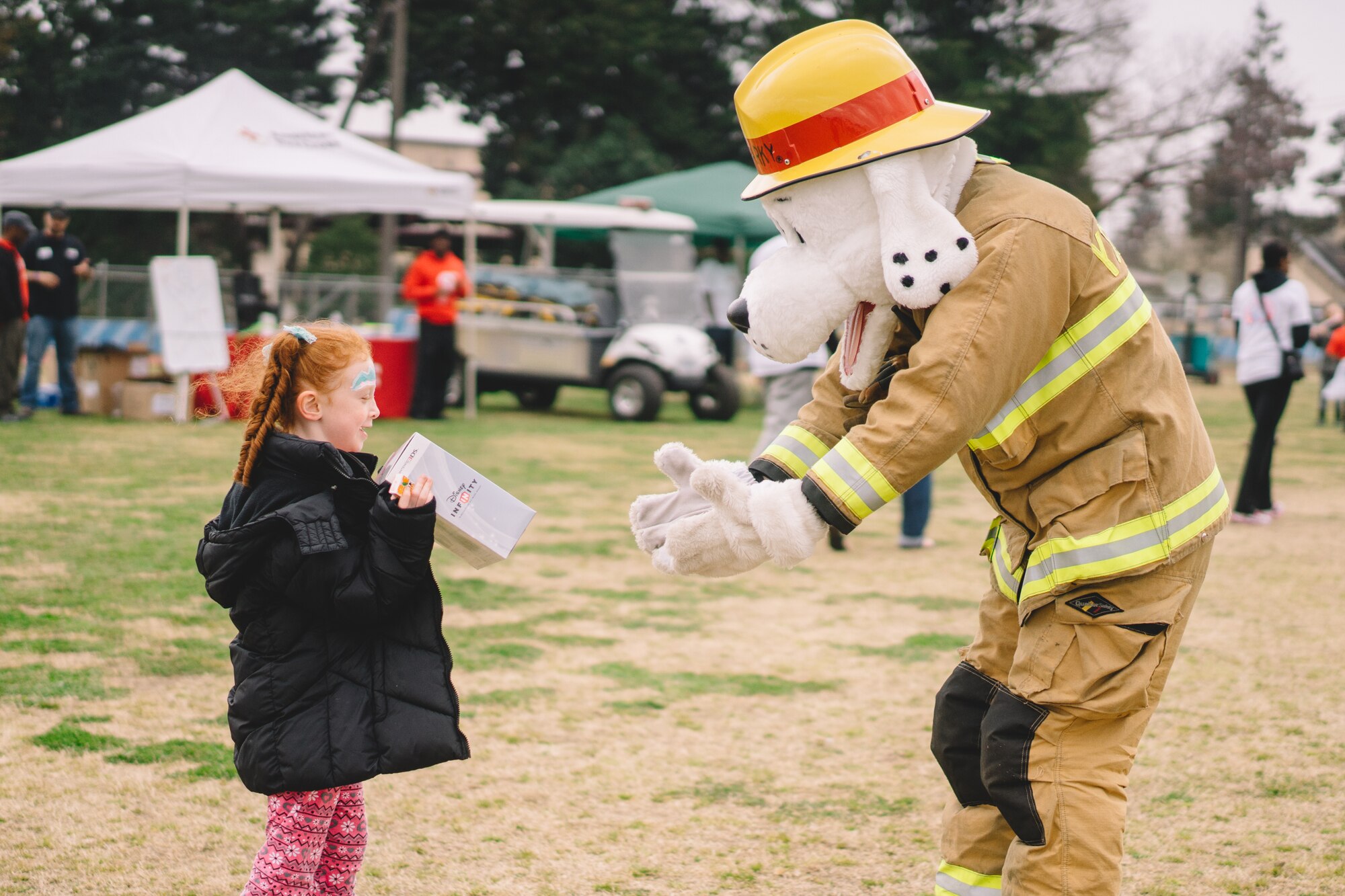 A child plays with Sparky the Fire Dog during the Youth Festival at Yokota Air Base, Japan, April 3, 2016. The festival is part of a month-long celebration which reinforces to military children that they are a key part of the armed forces community. (U.S. Air Force photo by Airman 1st Class Delano Scott/Released)