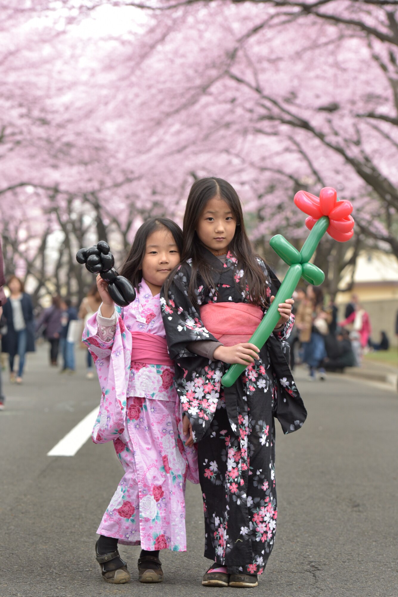 Festival attendees pose for a picture during the Sakura Spring Festival at Yokota Air Base, Japan, April 2, 2016. The festival consisted of band performances, dancers, Taiko drummers and food booths, offering a chance for Japanese citizens to experience American culture within the base’s perimeter. Approximately 5,000 visitors attended the event to celebrate the coming of spring. (U.S. Air Force photo by Machiko Imai/Released)