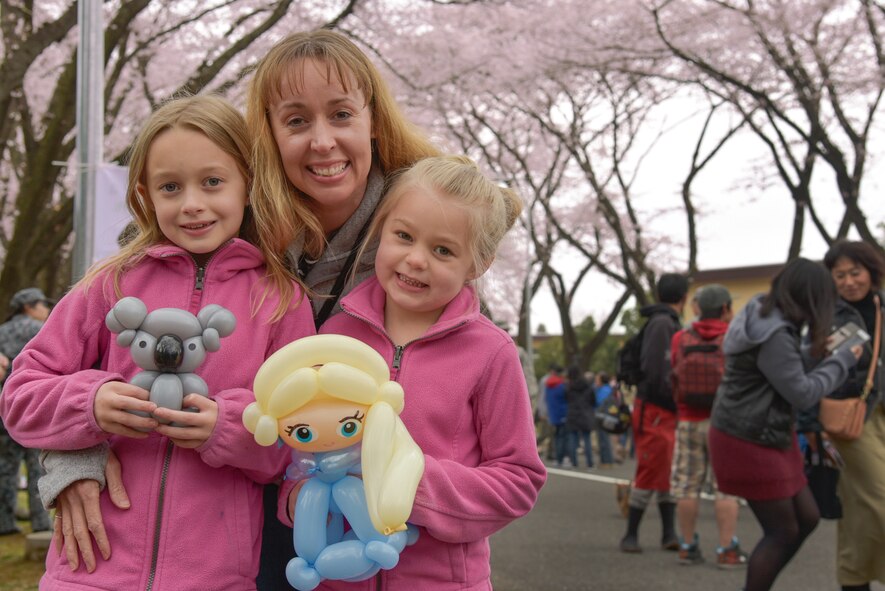 Senior Master Sgt. Stacia Taylor, 374th Force Support Squadron, and her daughters pose for a picture during the Sakura Spring Festival at Yokota Air Base, Japan, April 2, 2016. Festivities of the day included bouncy castles, juggling, face painting and balloon animals. (U.S. Air Force photo by Machiko Imai/Released)