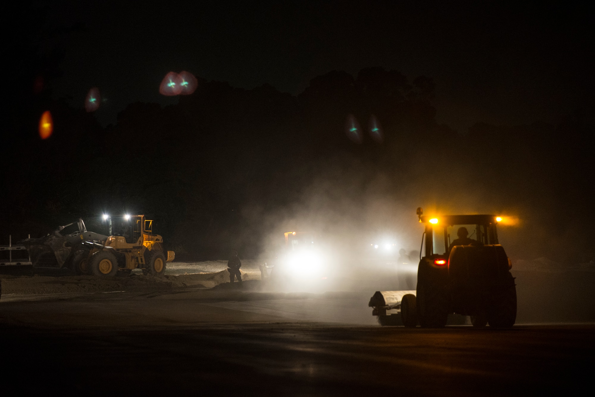 U.S. Air Force Airmen of 18th Civil Engineer Squadron conduct a nighttime airfield damage repair contingency exercise at the Silver Flag training site April 5, 2016, on Kadena Air Base, Japan. Civil engineer Airmen demonstrated their capability to reestablish a damaged runway despite operating in a hostile environment and sustaining casualties from attacks. (U.S. Air Force photo by Senior Airman Peter Reft)