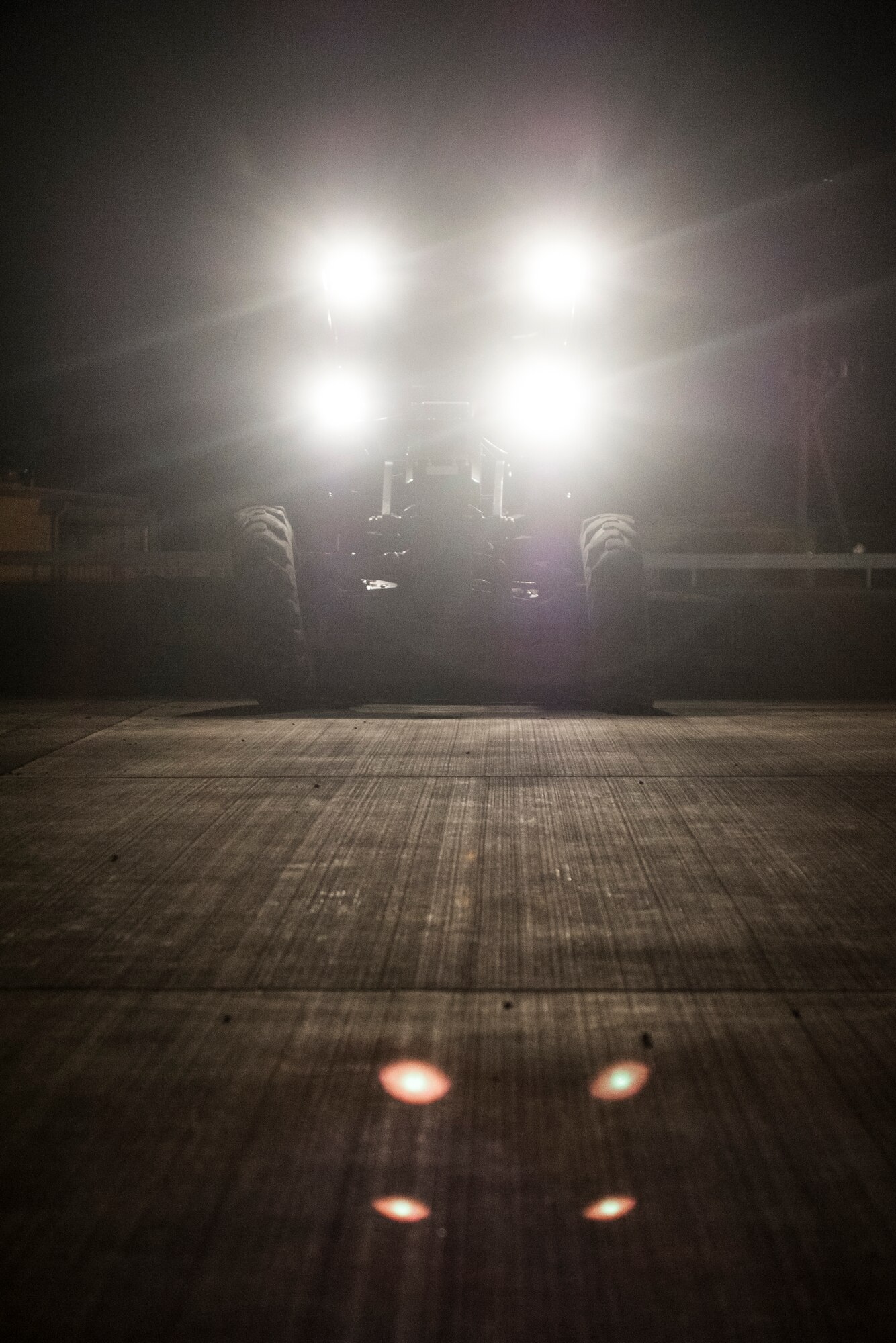 A U.S. Air Force Airman from the 18th Civil Engineer Squadron maneuvers a grader plow during an airfield damage repair contingency exercise at the Silver Flag training site April 5, 2016, at Kadena Air Base, Japan. 18th CES Airmen conducted training to enhance their readiness to persevere with continuous airfield repair operations in a hostile environment. (U.S. Air Force photo by Senior Airman Peter Reft)