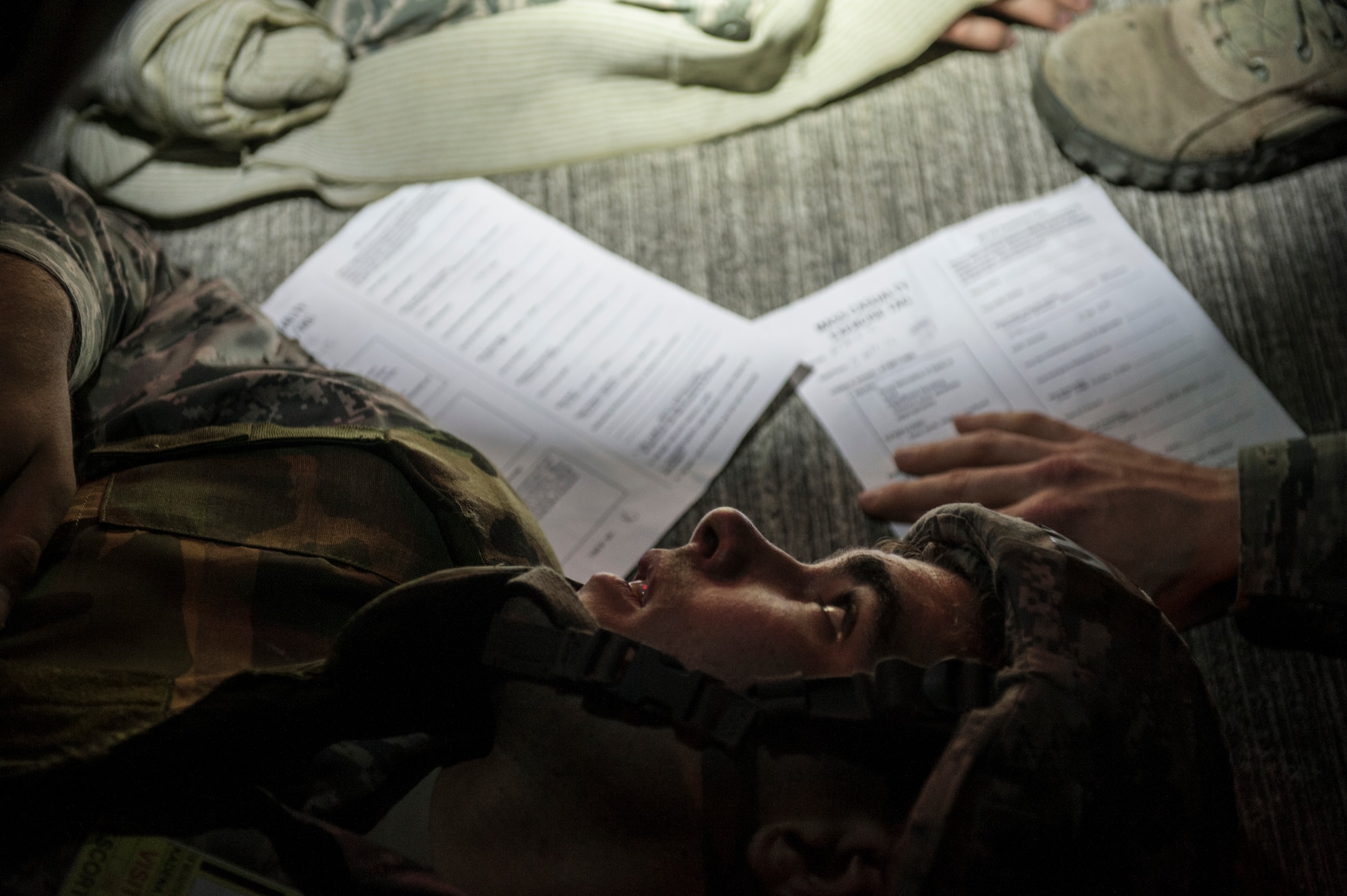 A U.S. Air Force Airman from the 18th Civil Engineer Squadron participates in a mass casualty exercise during airfield damage repair training at the Silver Flag training site April 5, 2016, on Kadena Air Base, Japan. The 18th CES tested their resolve to sustain casualties in a combat zone while maintaining continuous nighttime airfield repair operations. (U.S. Air Force photo by Senior Airman Peter Reft)