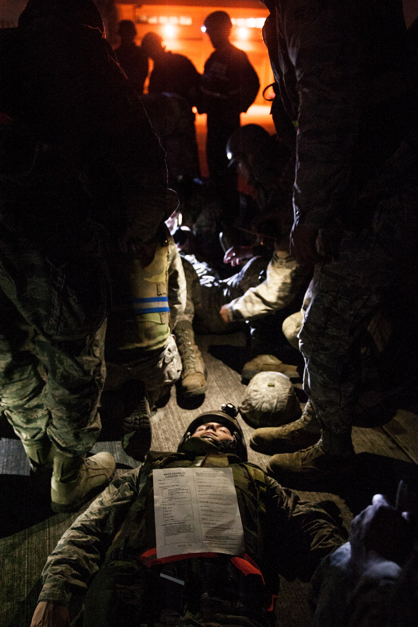 U.S. Air Force Airmen from the 18th Civil Engineer Squadron conduct self-aid and buddy care during a training exercise at the Silver Flag training site April 5, 2016, on Kadena Air Base, Japan. During the exercise, Airmen were tested on their ability to perform continuous airfield damage repairs despite air attacks and sustained casualties. (U.S. Air Force photo by Senior Airman Peter Reft)